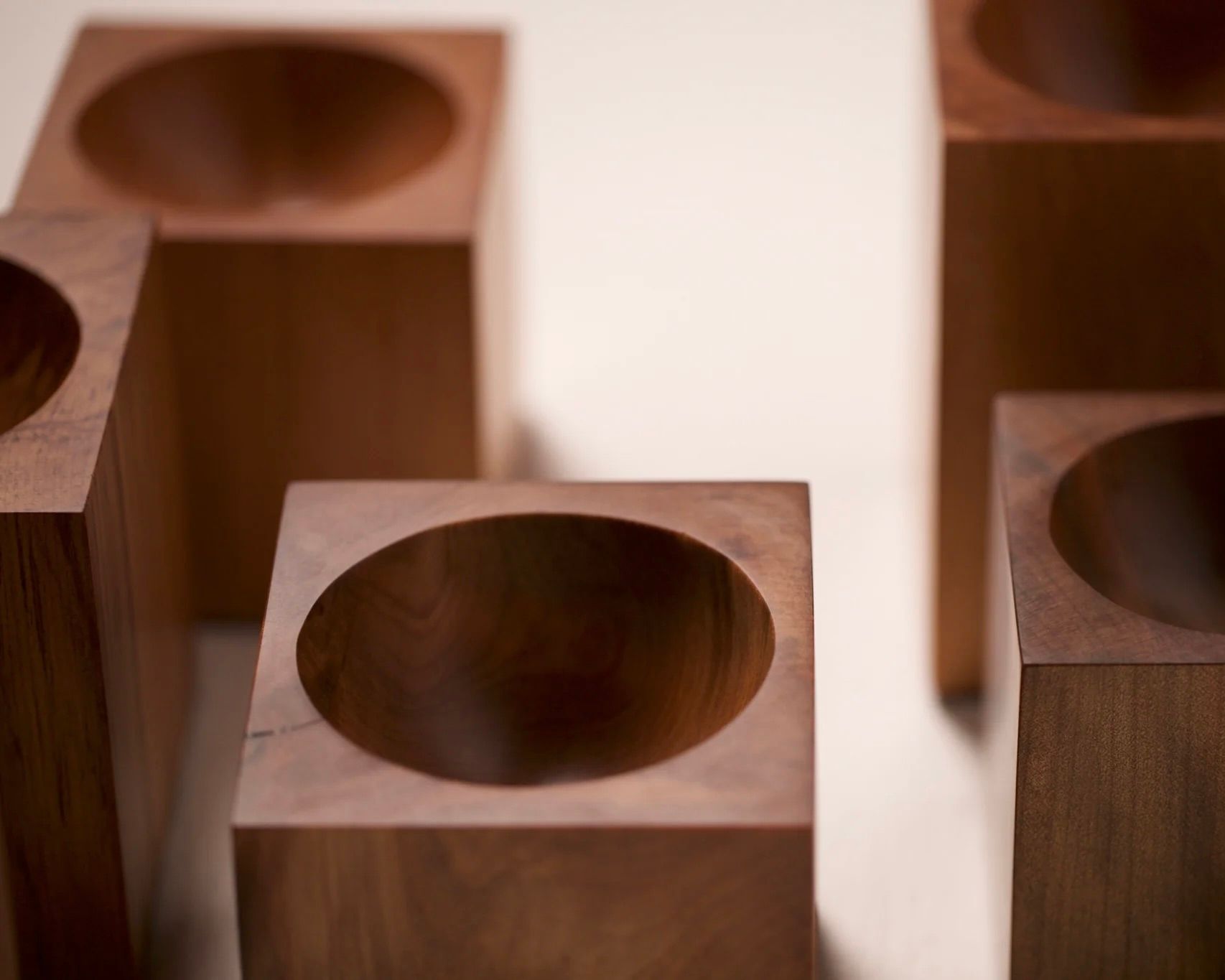 a group of Courtney Petleys Hemisphere bowls made from end grain native New Zealand timbers, hand carved in Aotearoa