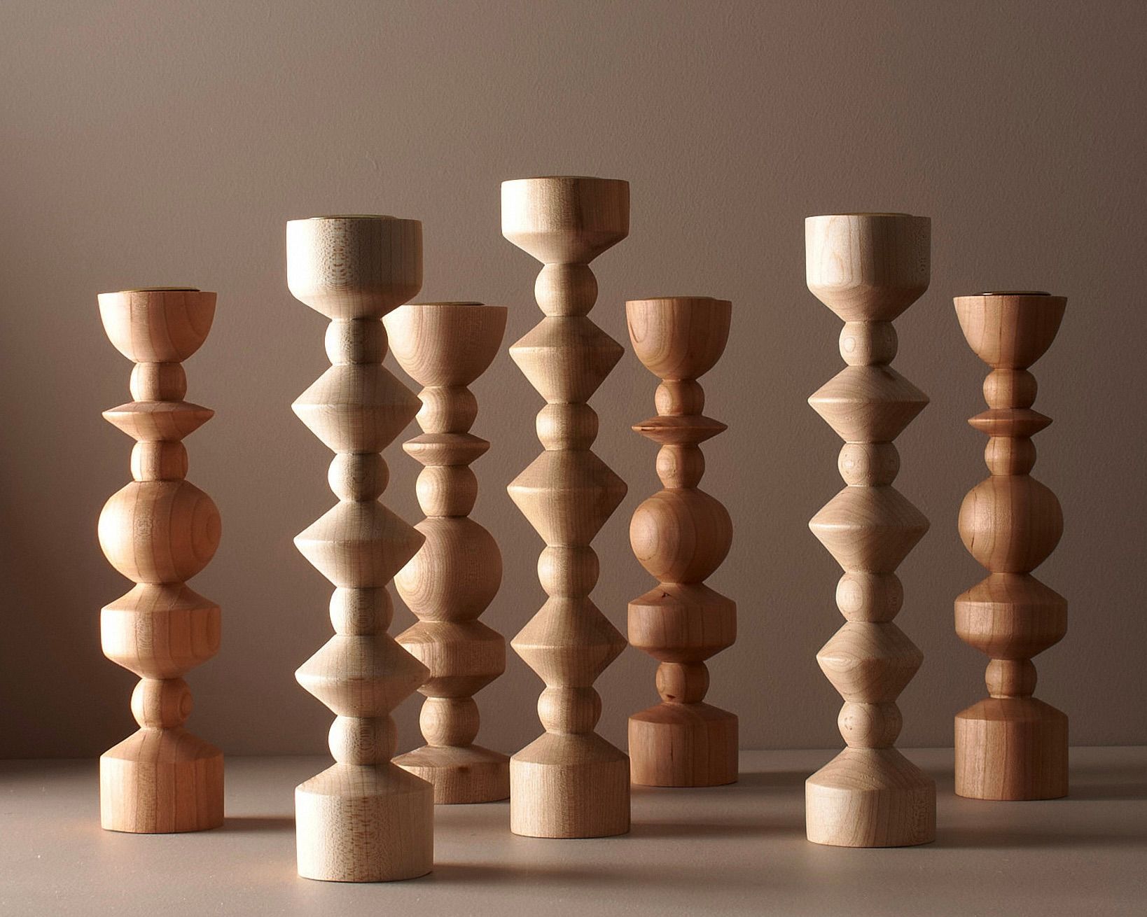 Elise mclauchlans tall and medium tapered candle holders on a brown moody background