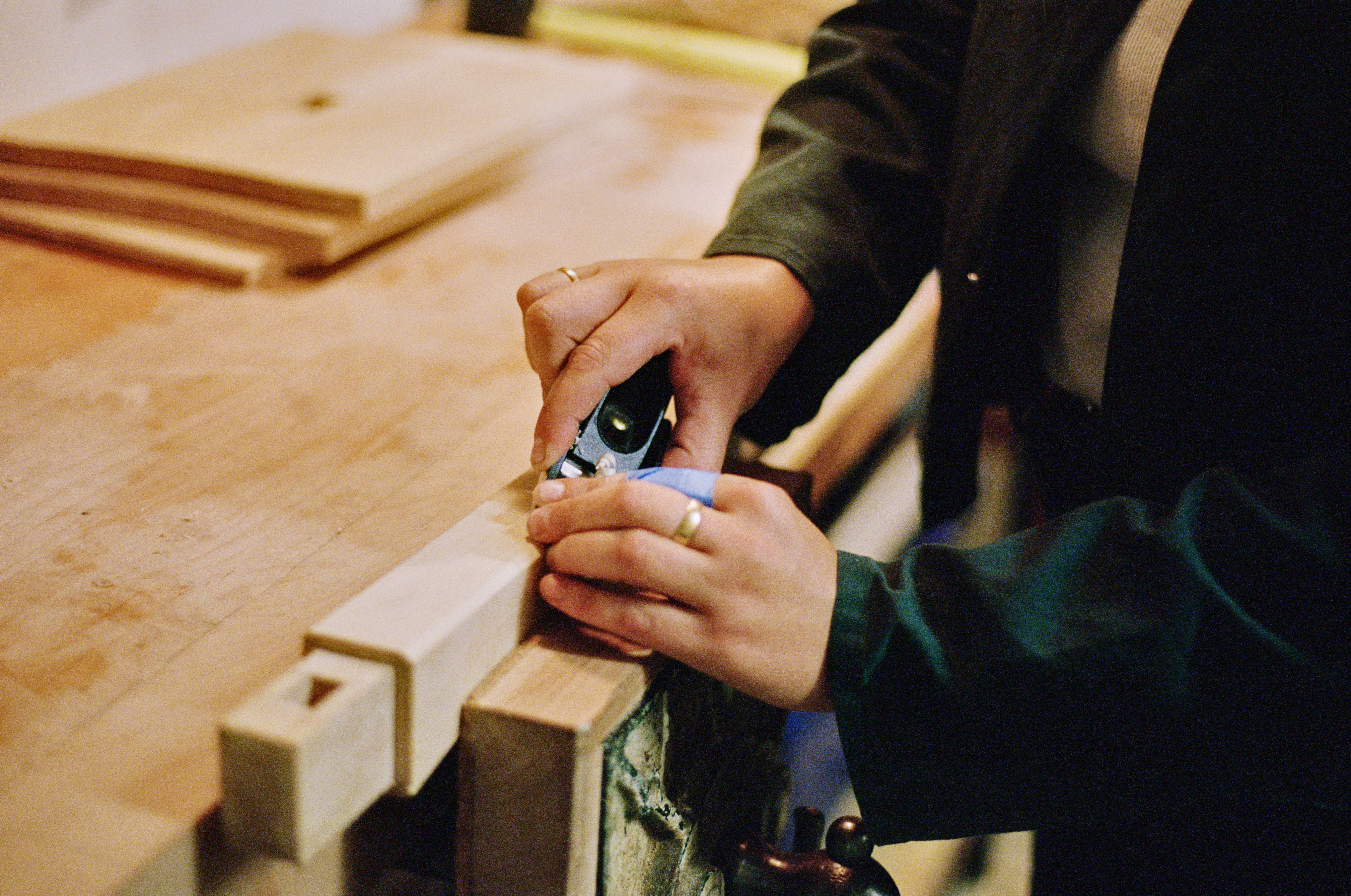 Josephine Jelicich in her workshop hand carving on a table