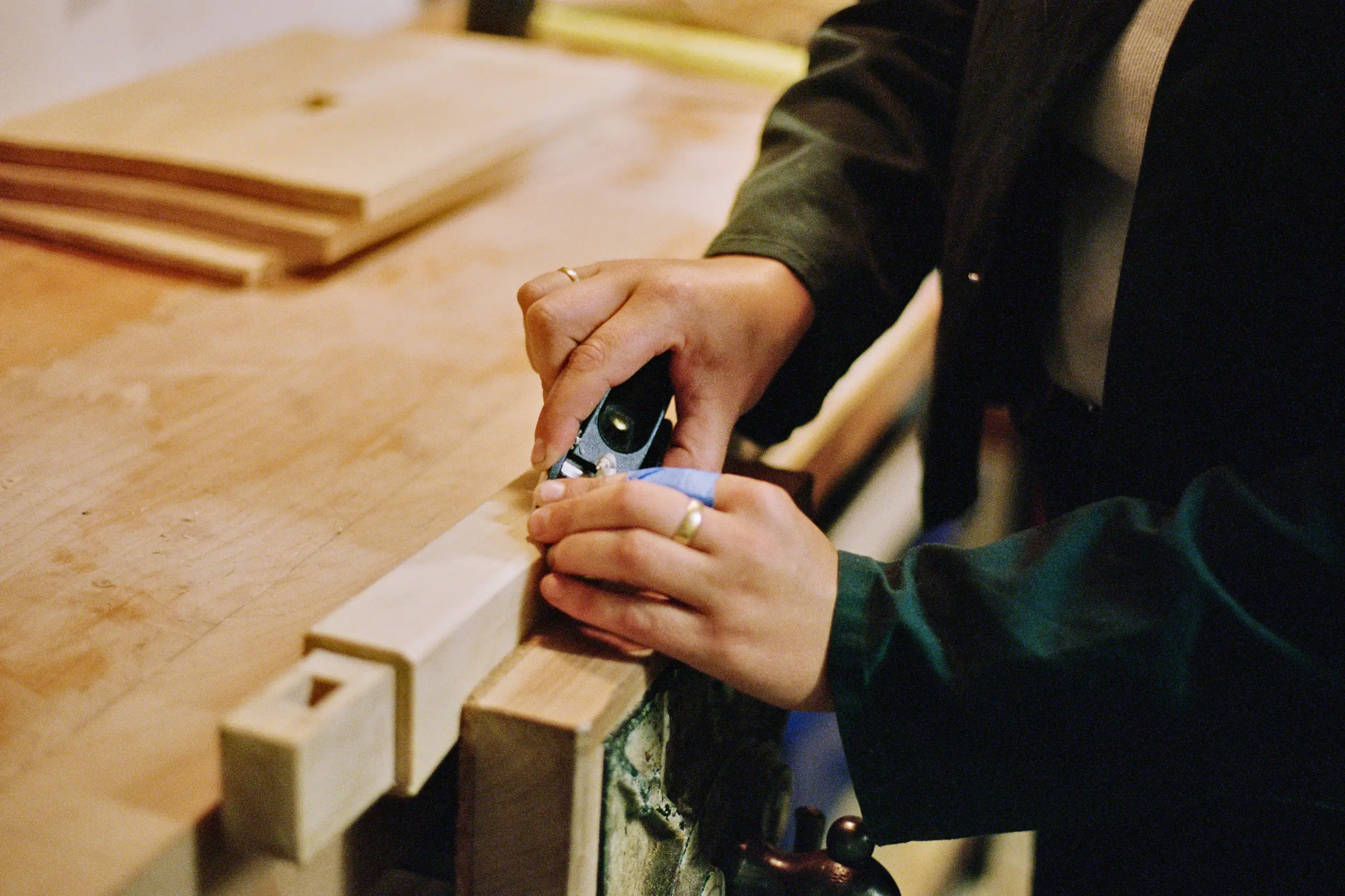 Josephine Jelicich in her workshop hand carving on a table