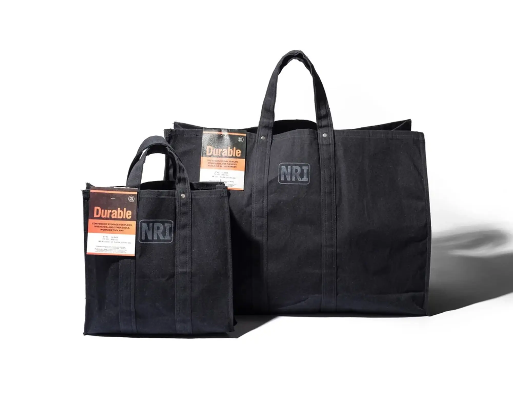 the Puebco labour tote bags in small and large next to each other