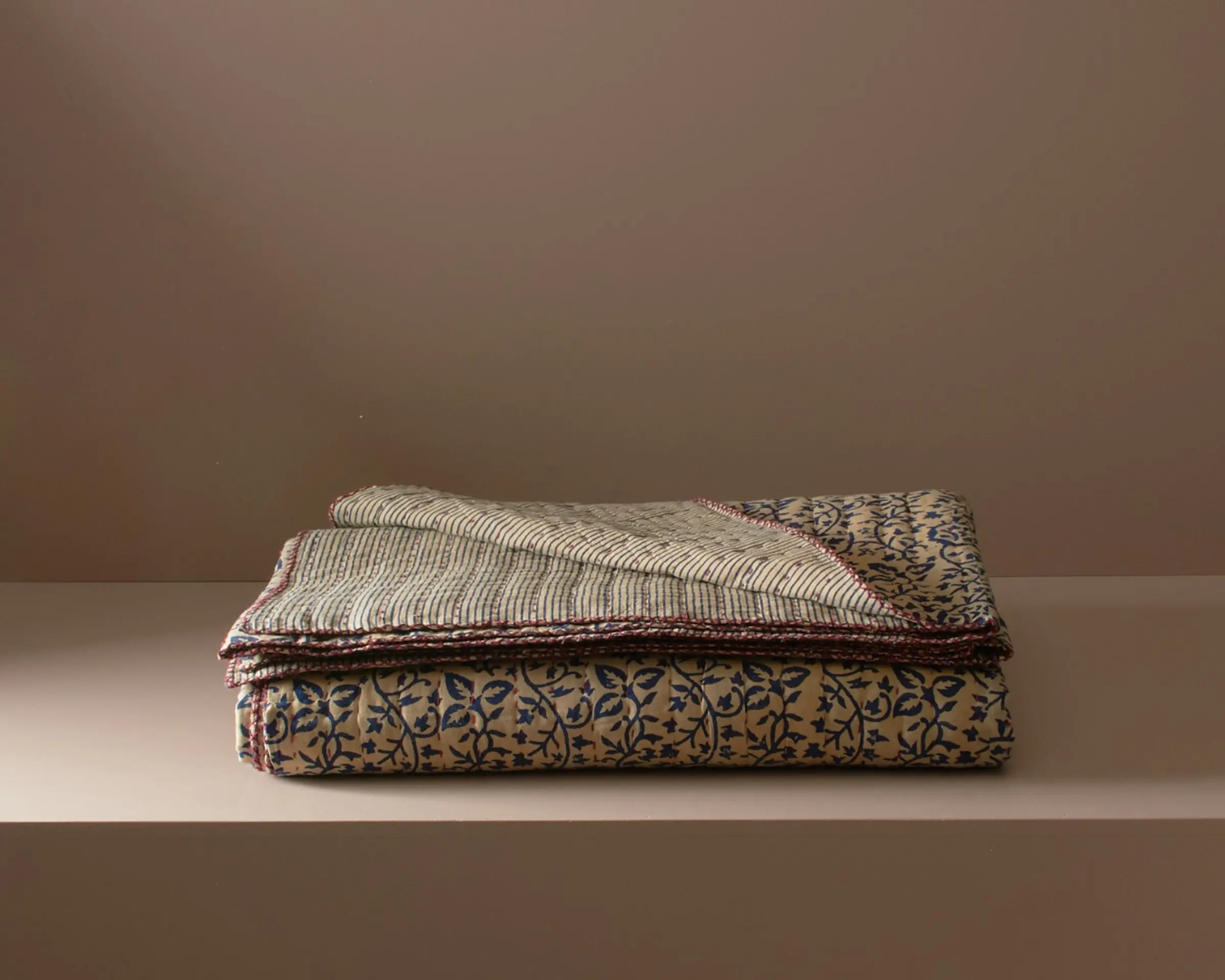 a block printed cotton quilt with floral designs