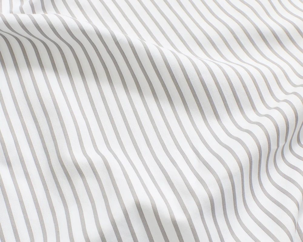 A close up detail shot of the Magniberg Wall Street Light grey stripe bedding made from 390 thread count pima cotton