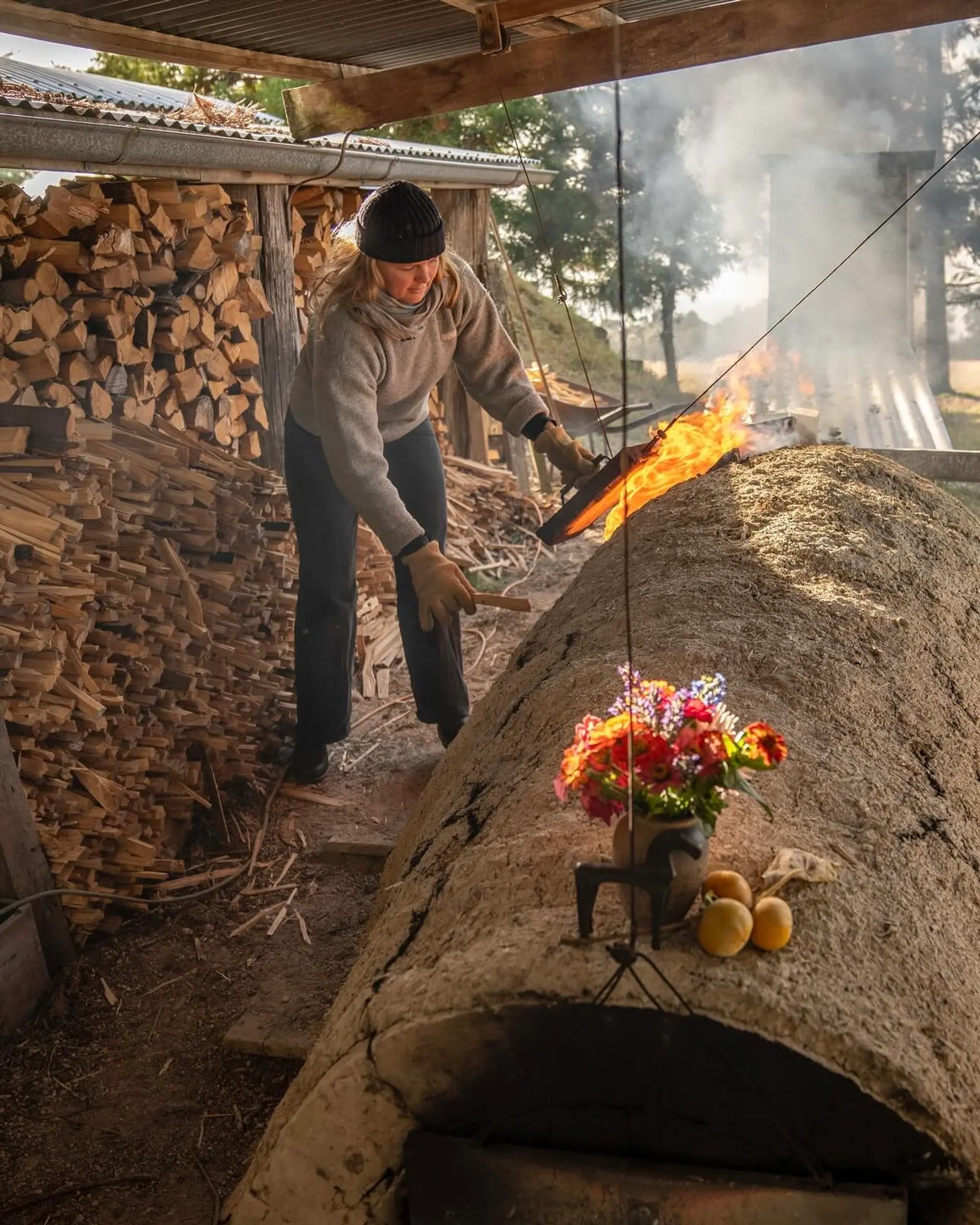 Holly rose Morgan at a wood kiln firing her ceramic pieces