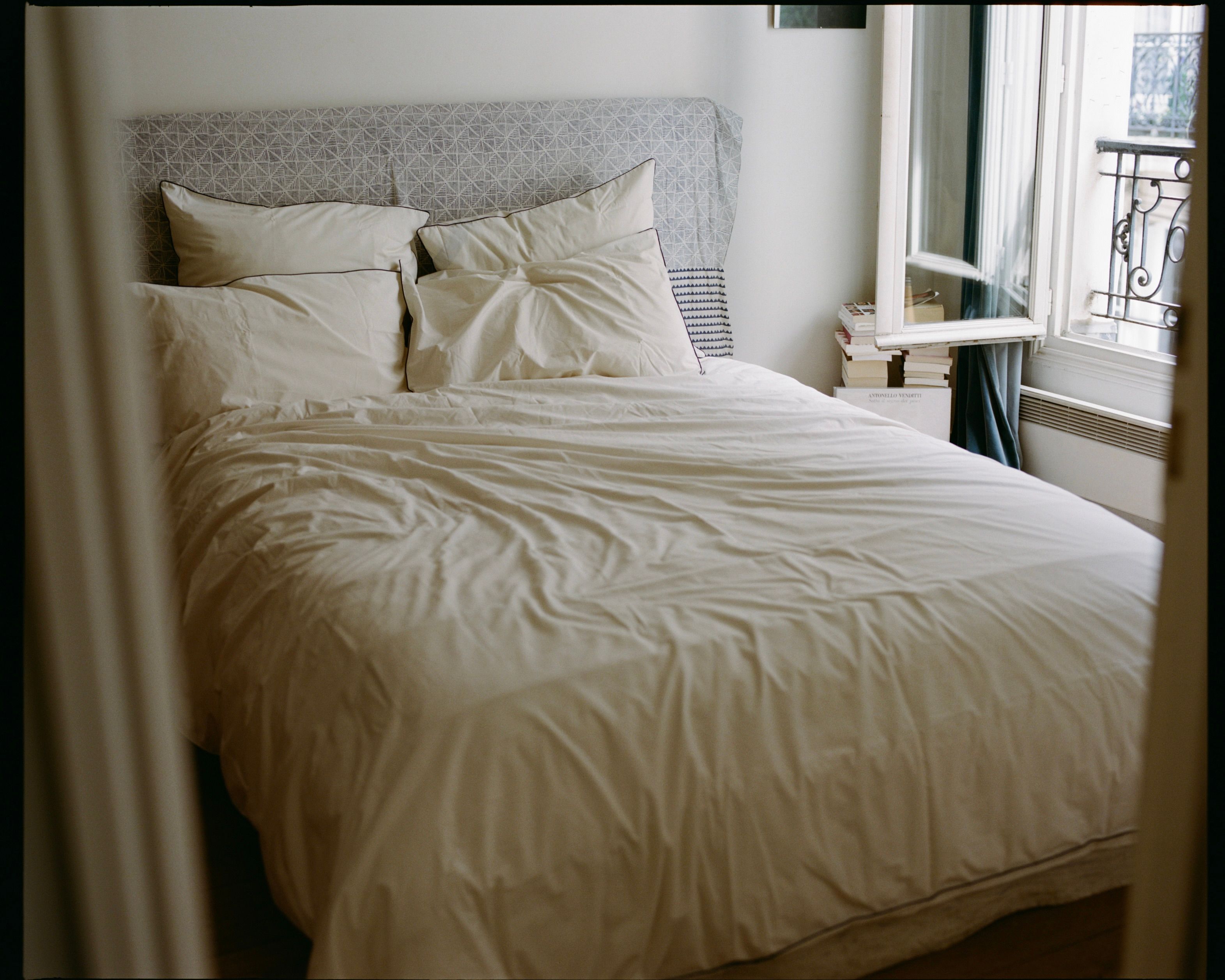 SUTRAM Canvas organic cotton percale bedding featuring a duvet cover, piped standard pillowcases and Euro pillowcases, styled in a light-filled heritage bedroom.