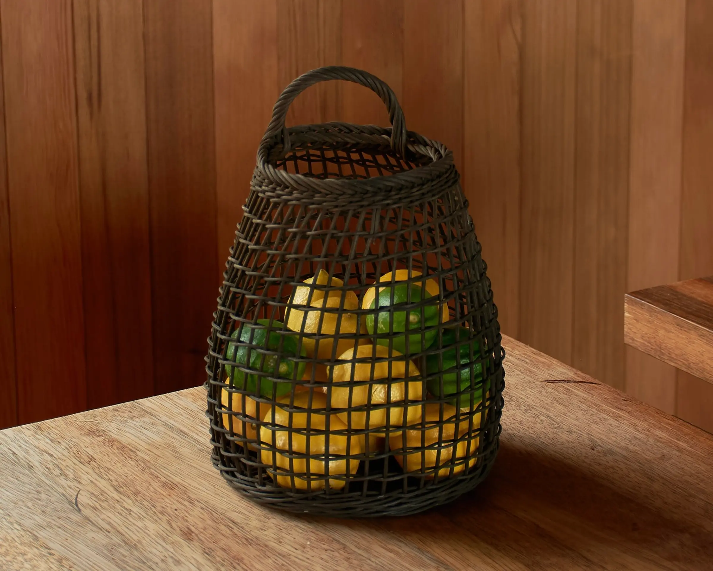 rattan woven lemon basket on a wooden bench