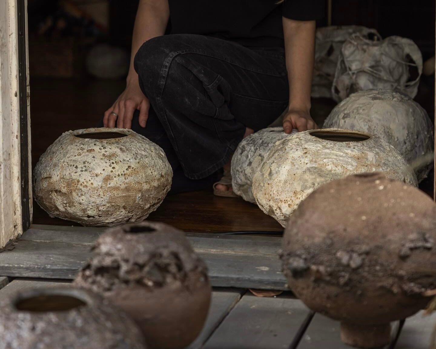 Maria of Loram ceramics with a group of her lava glaze vases