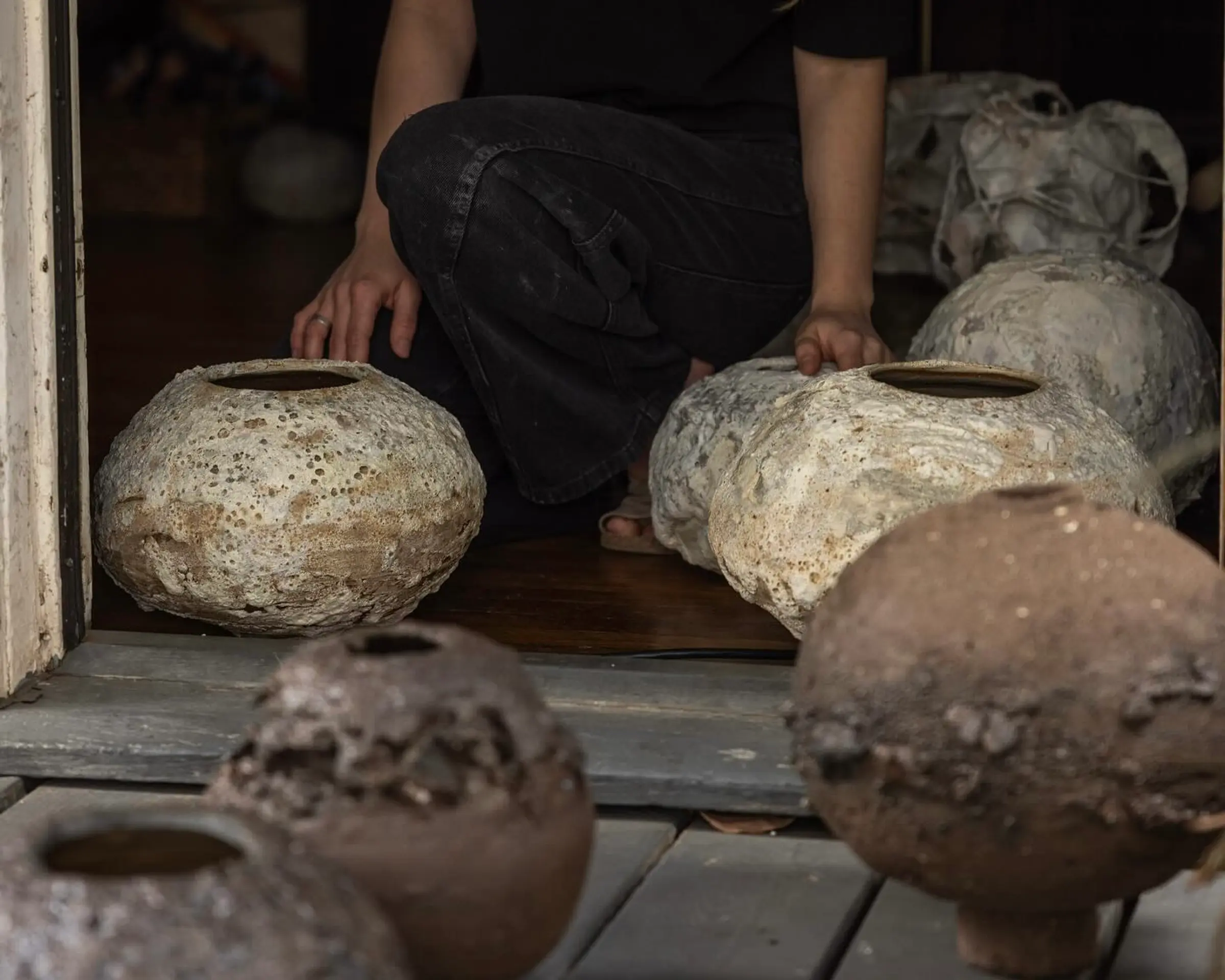 Maria of Loram ceramics with a collection of her lava glaze vases
