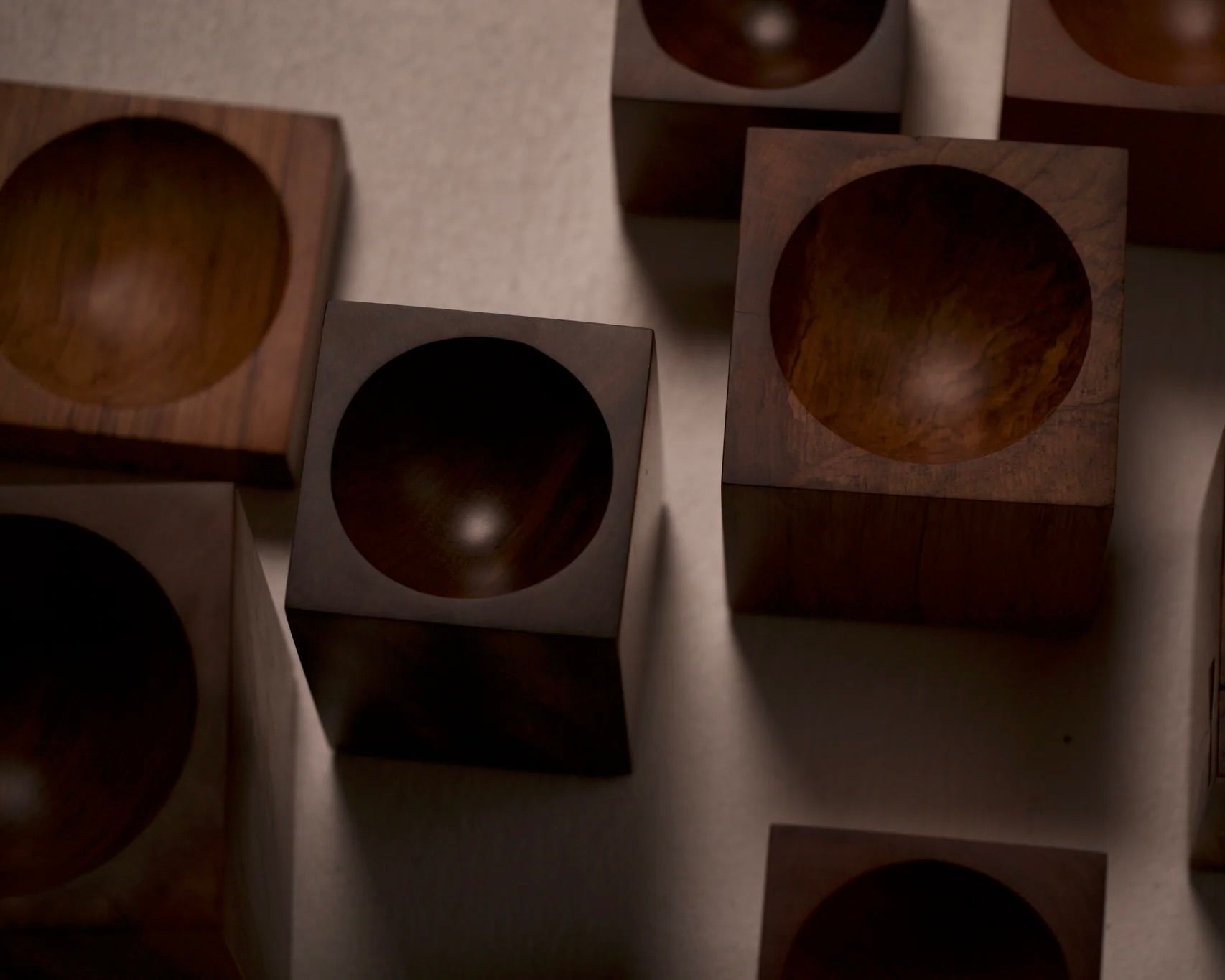 a group of Courtney Petleys Hemisphere bowls made from end grain native New Zealand timbers, hand carved in Aotearoa