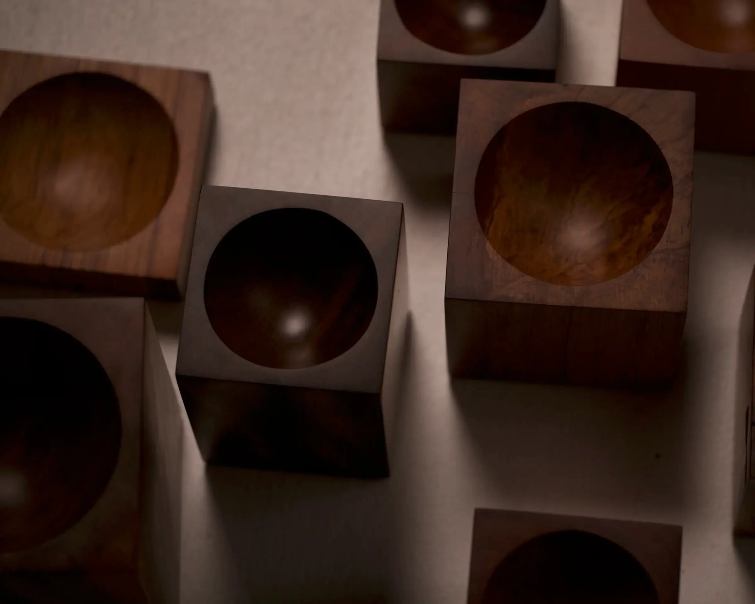 a group of Courtney Petleys Hemisphere bowls made from end grain native New Zealand timbers, hand carved in Aotearoa