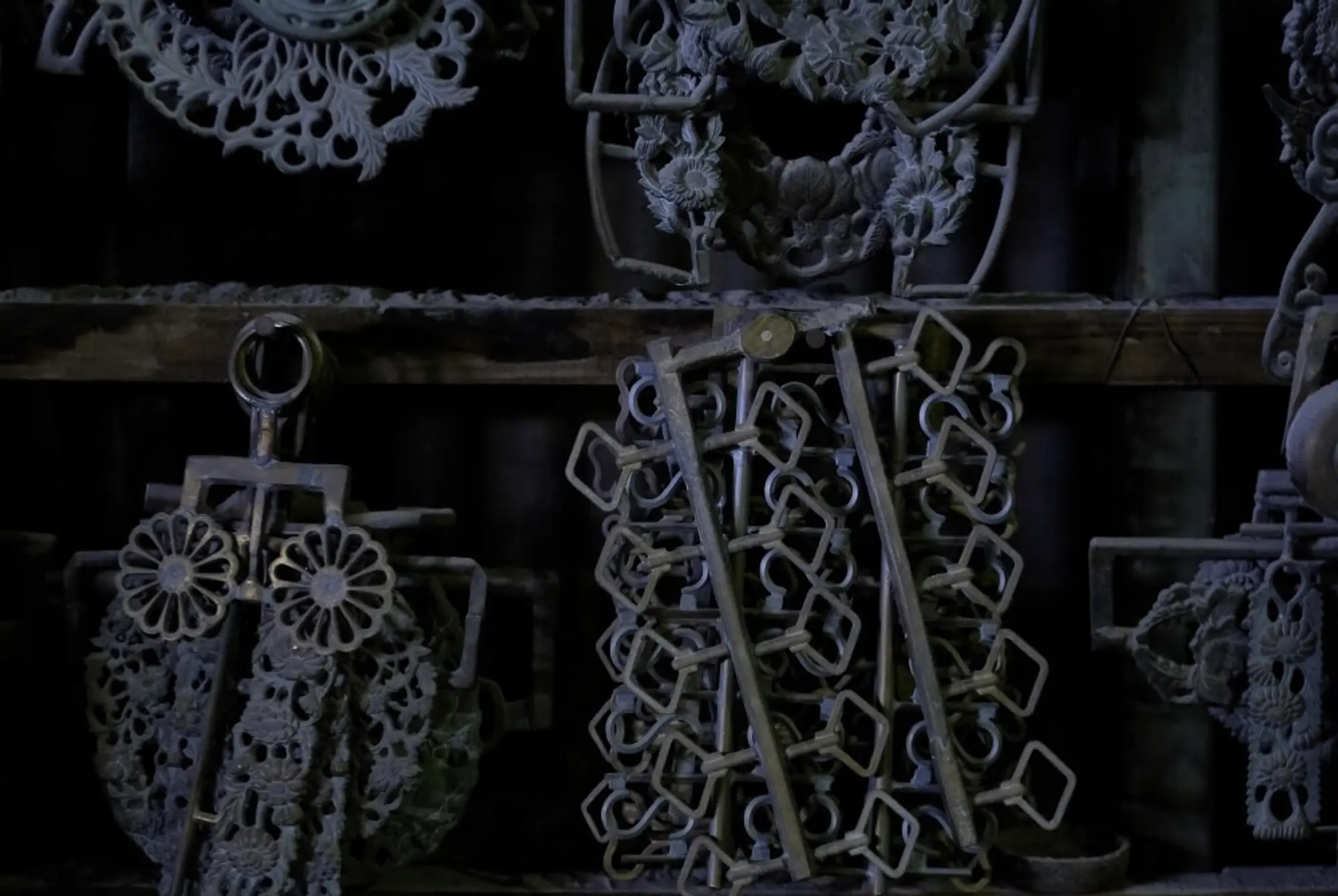 brass filagree monastery castings hanging on a wall a moody dark photo
