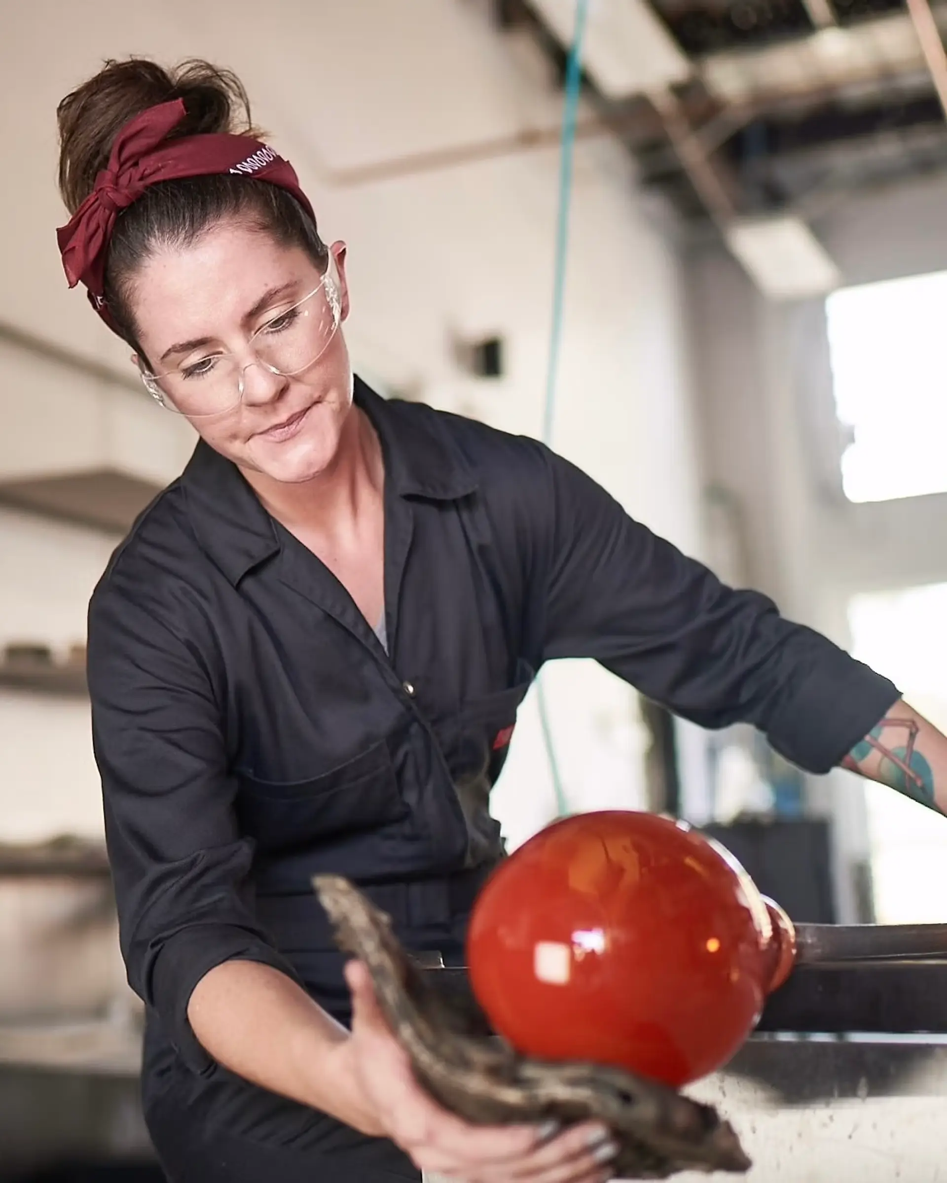 Lauren hunt blowing glass in a studio