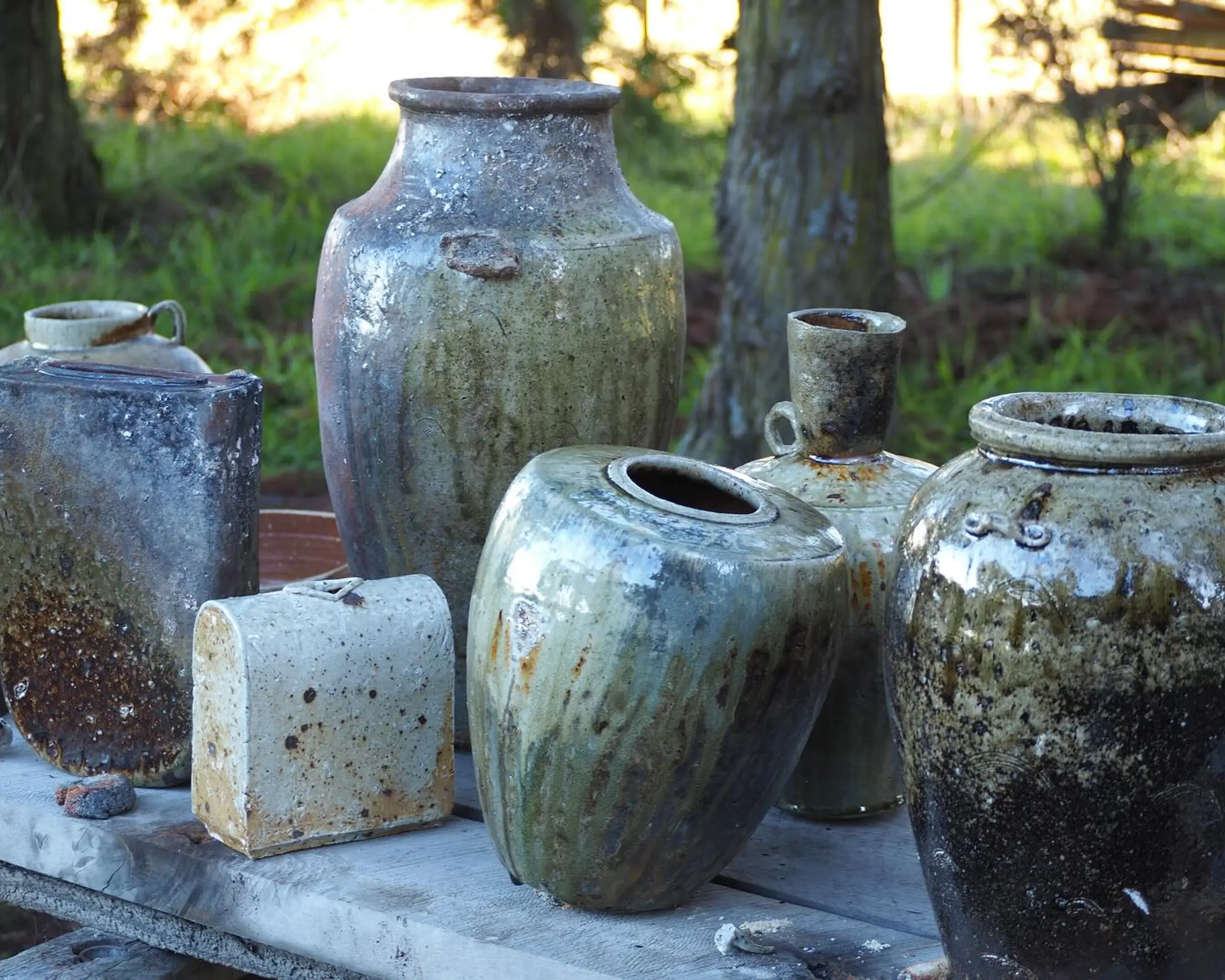 A collection of ceramics by Holly rose Morgan, Anagram wood fired pieces outside on a table top