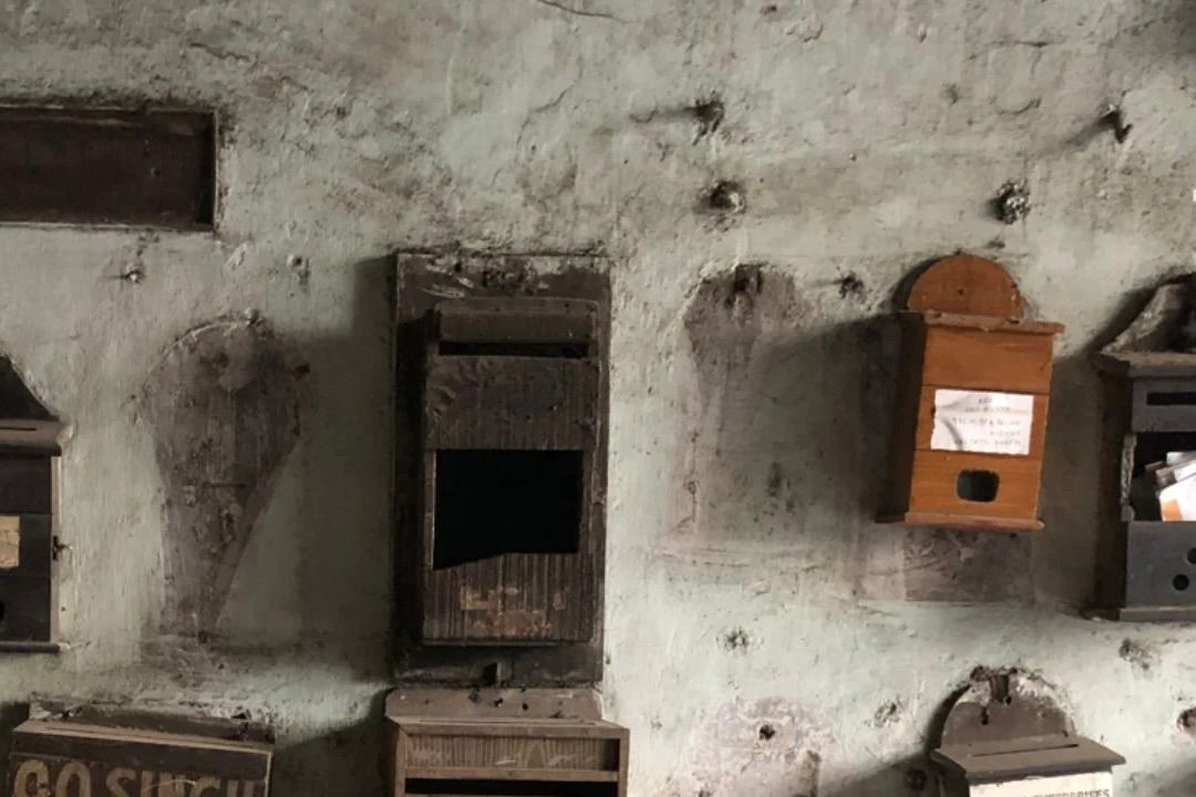a collection of  vintage wooden boxes on a concrete wall 