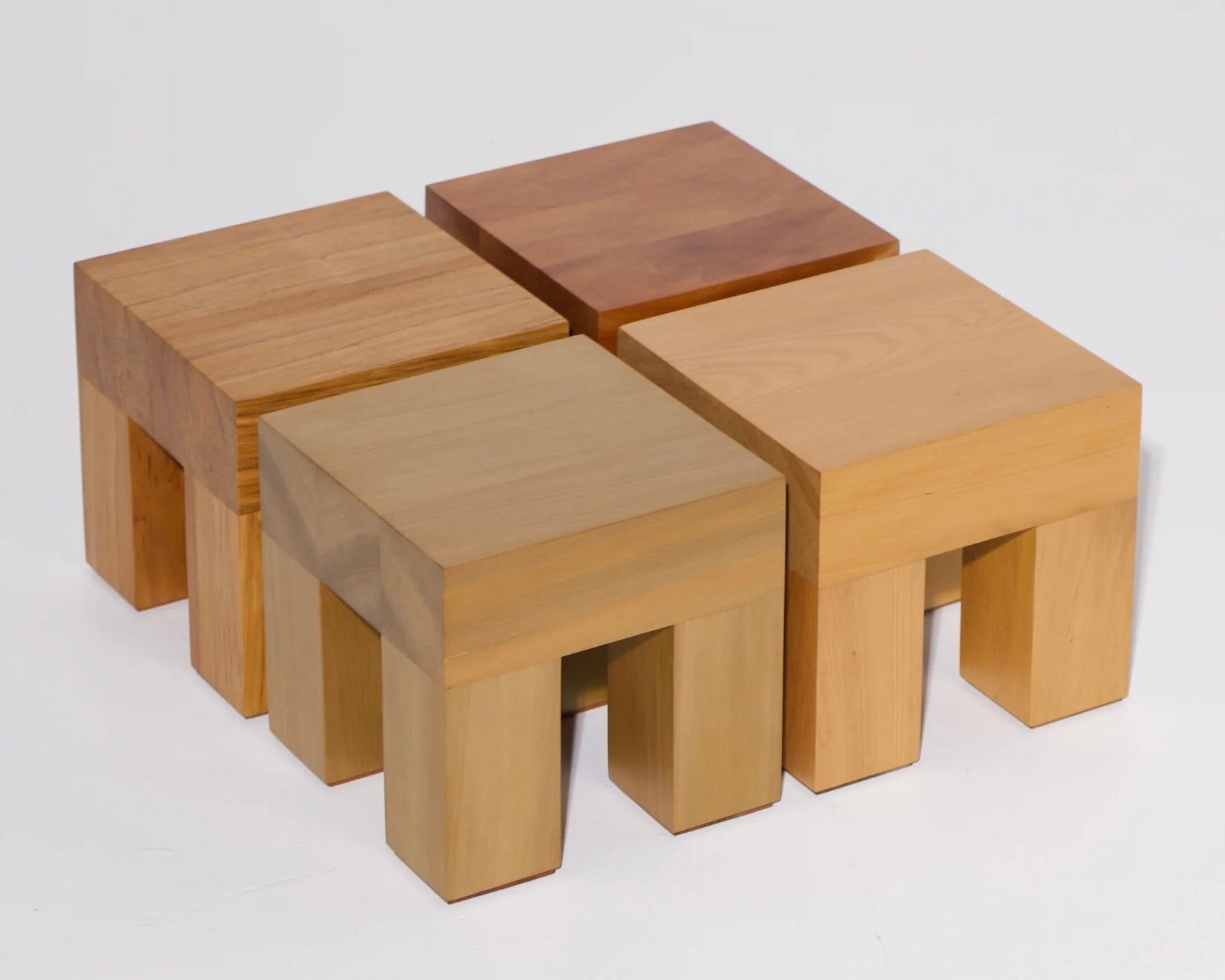 A collection of Courtney Petleys square low stools hand made from local New Zealand timbers.