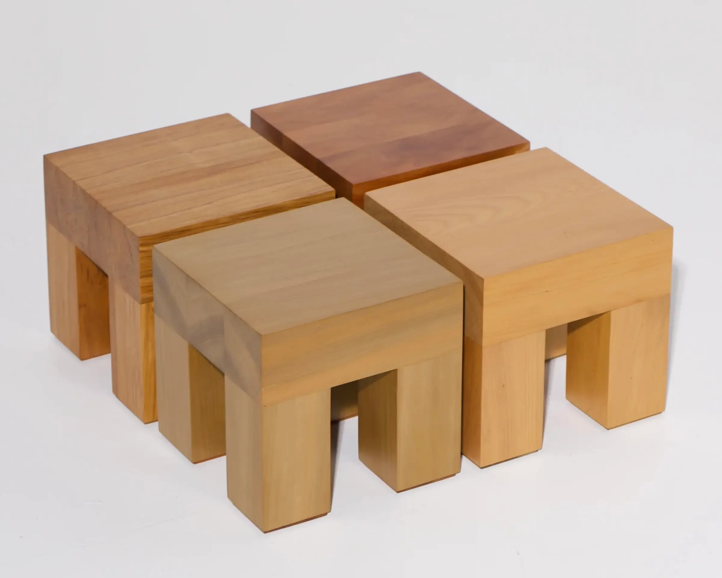 A collection of Courtney Petleys square low stools hand made from local New Zealand timbers.