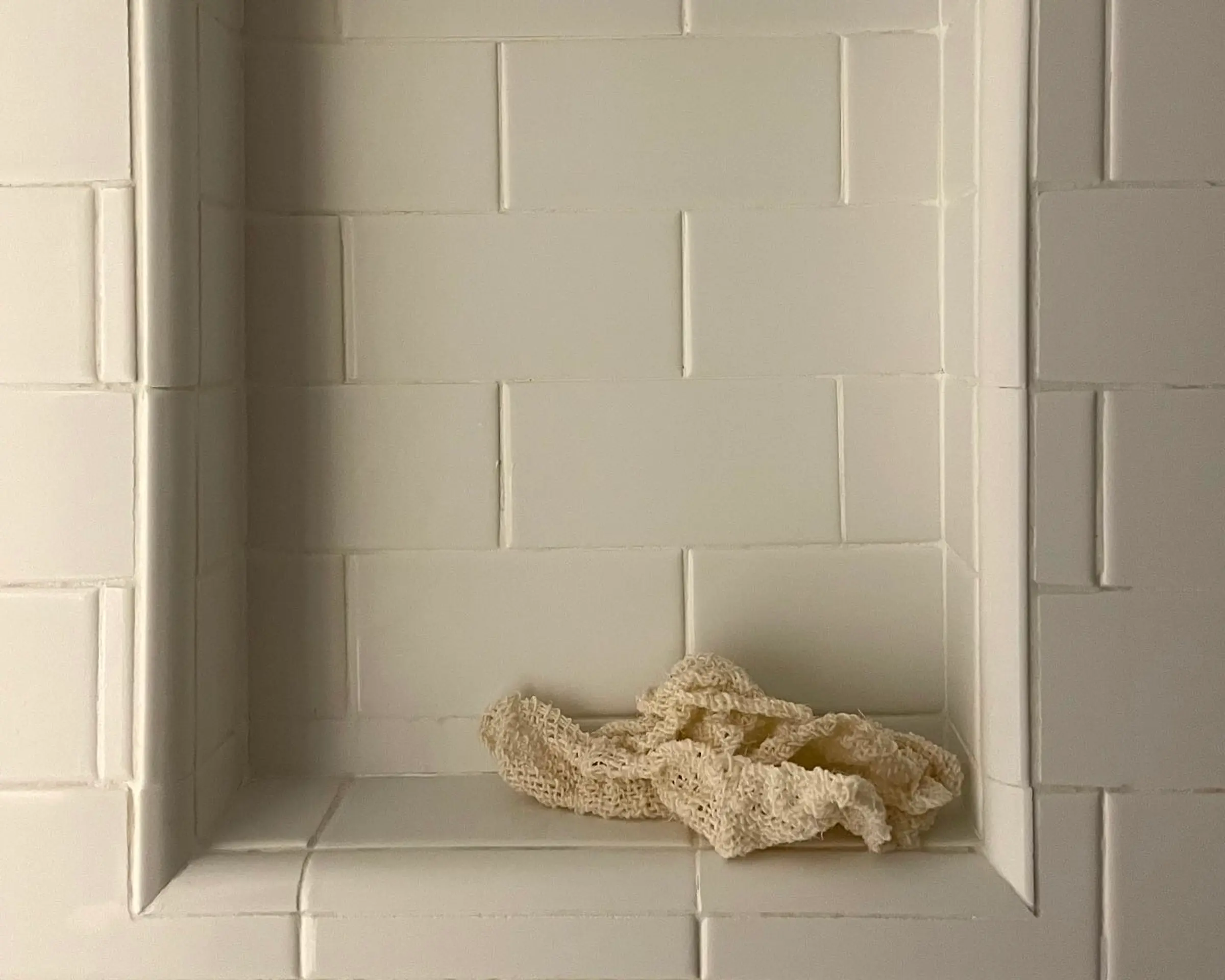 agave cloth sitting on a tiled bathroom ledge