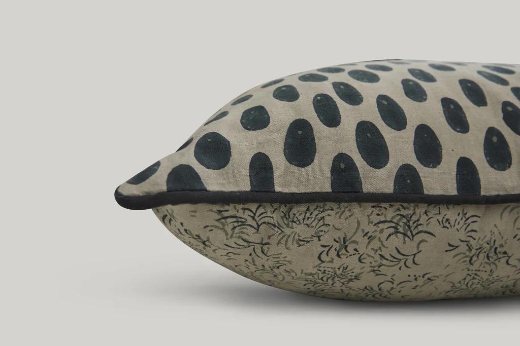 a close up of studio fords oracle lumbar cushion in grey and deep blue