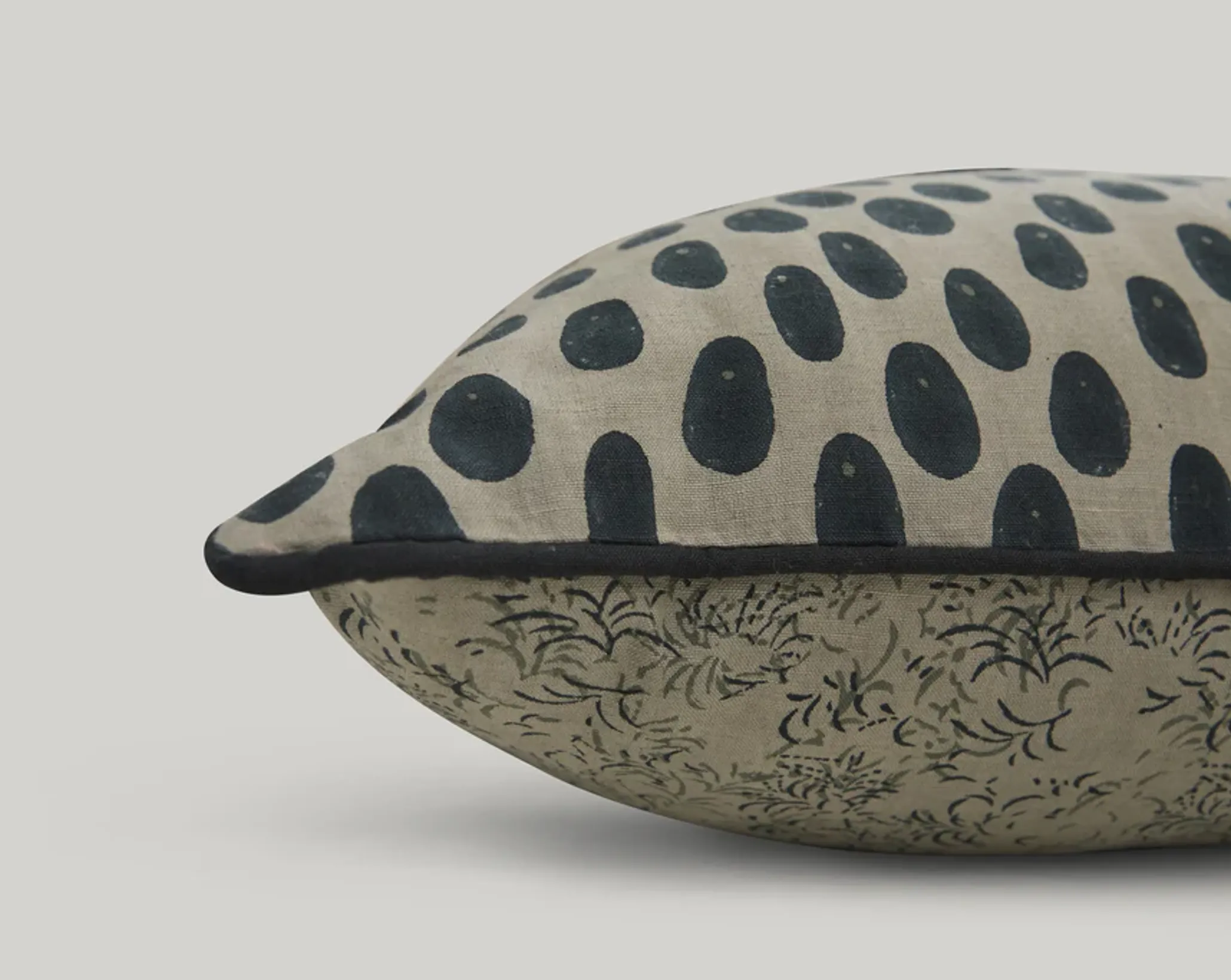 a close up of studio fords oracle lumbar cushion in grey and deep blue