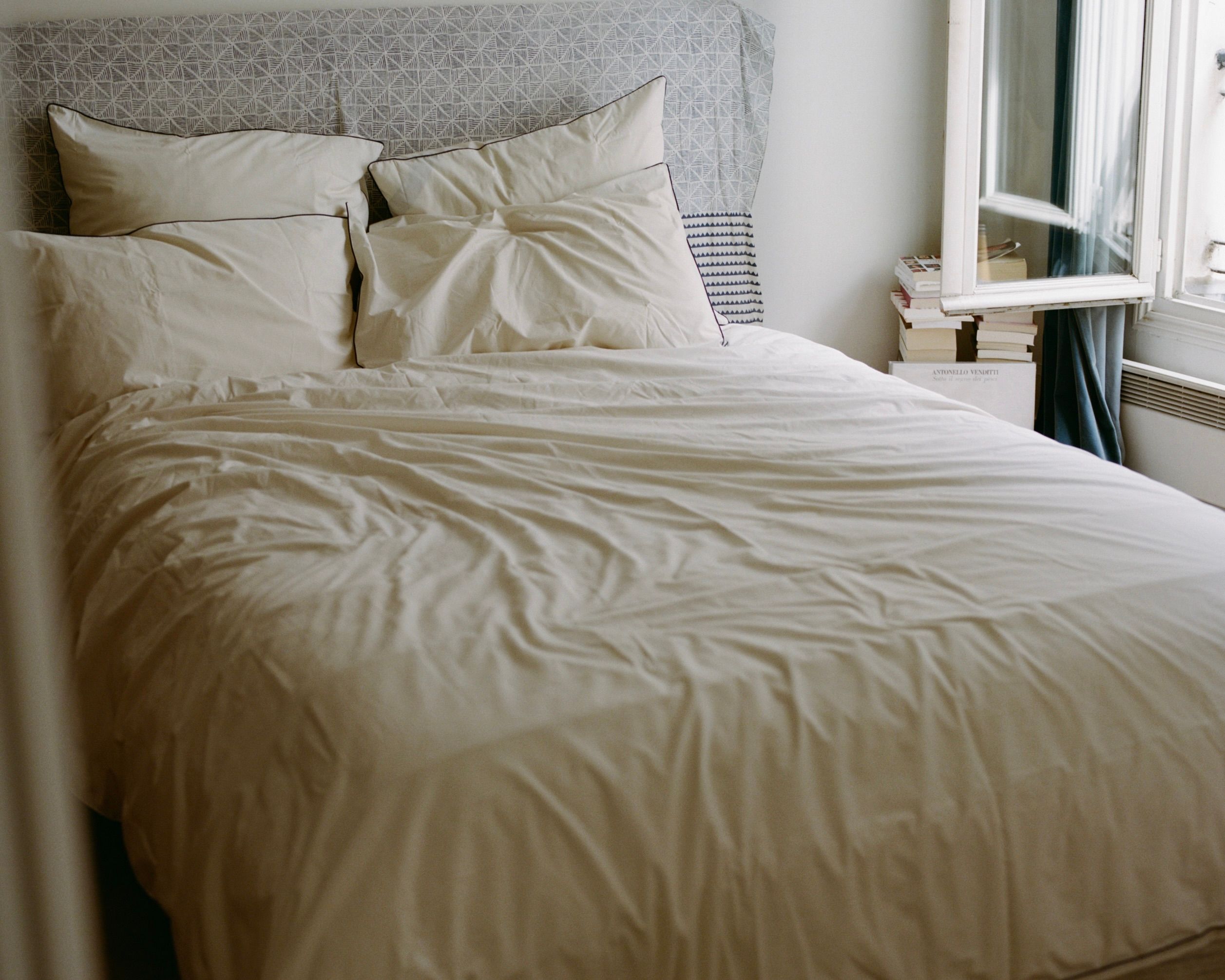 SUTRAM Canvas organic cotton percale bedding featuring a Canvas duvet cover, Canvas and Cinder piped pillowcases and Euro pillowcases, styled in a light-filled heritage bedroom.