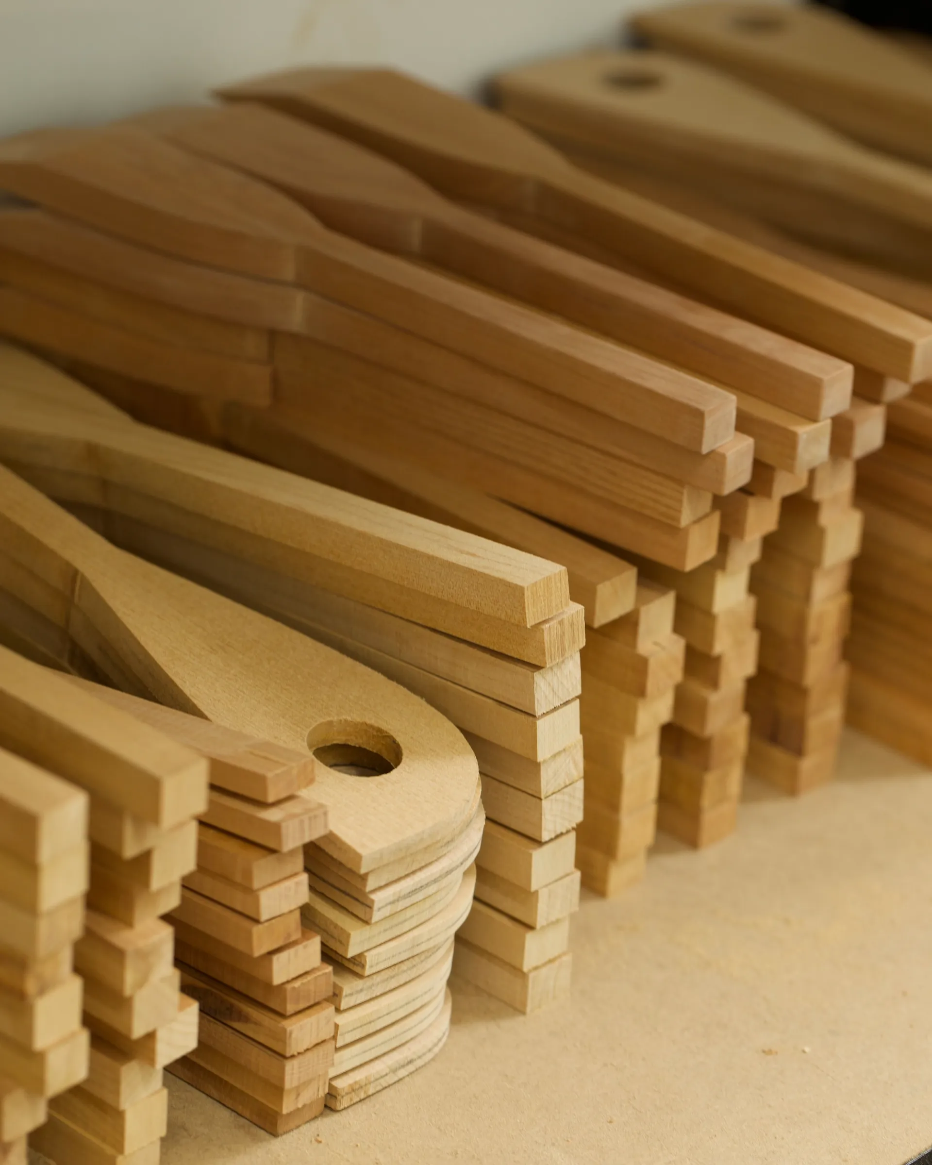 Stacks of hand carved kitchen utensils by New Zealand wood worker Courtney Petley