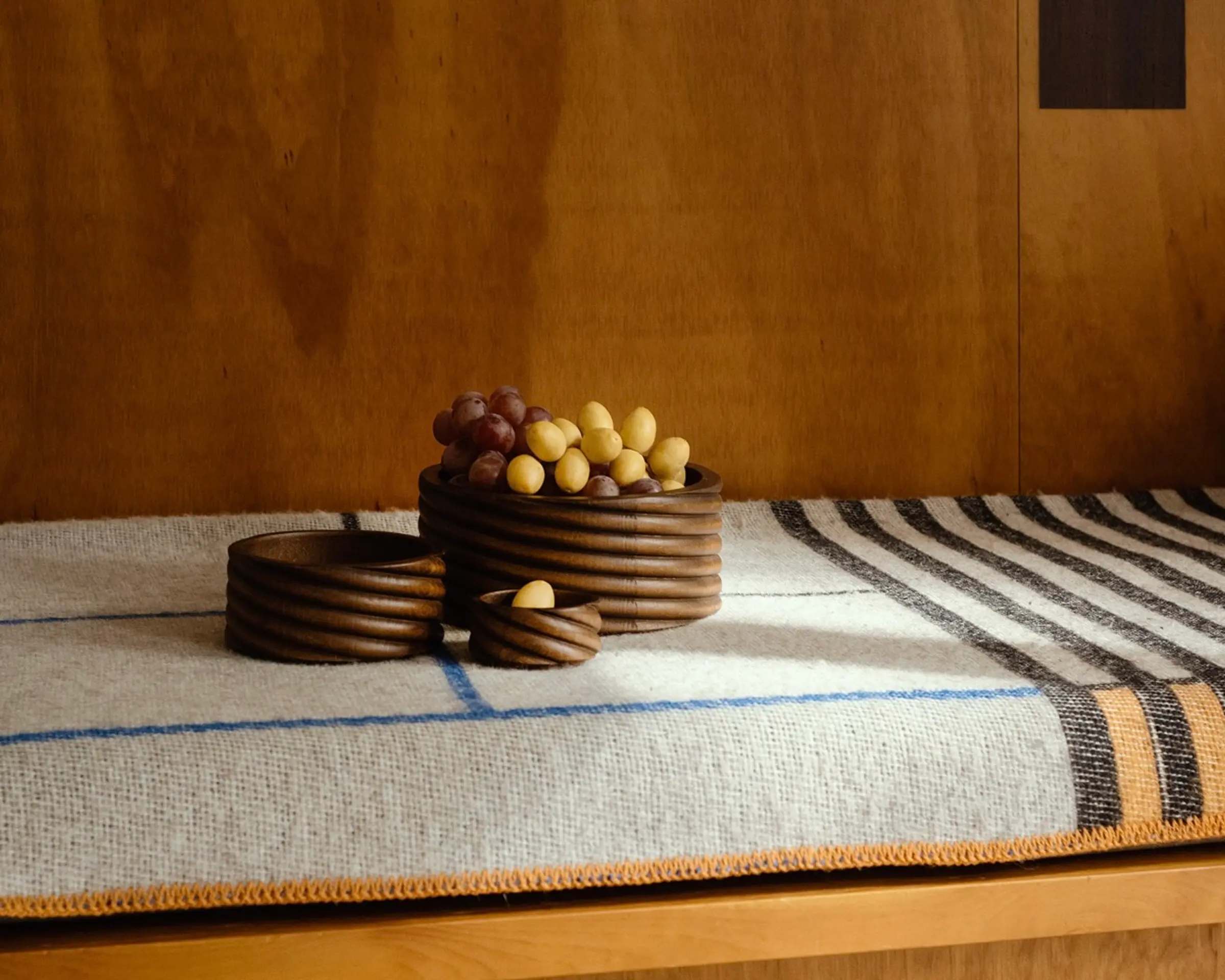 oros torsade collection of small medium and large bowls on a wool blanket