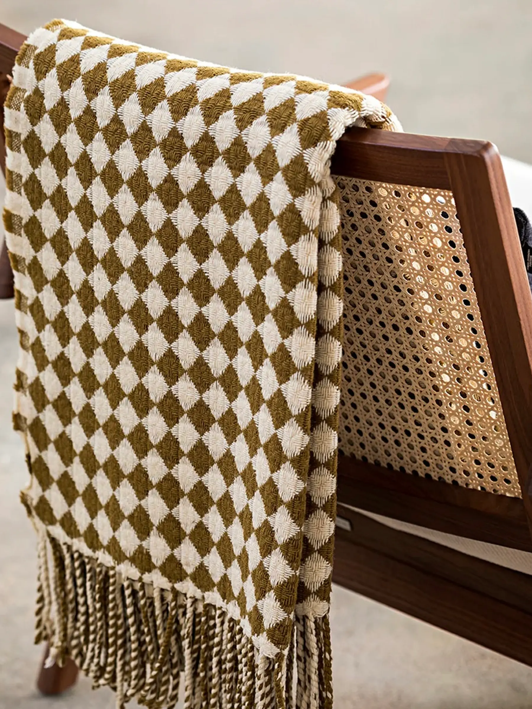 a Burel Factory blanket over the back of a chair