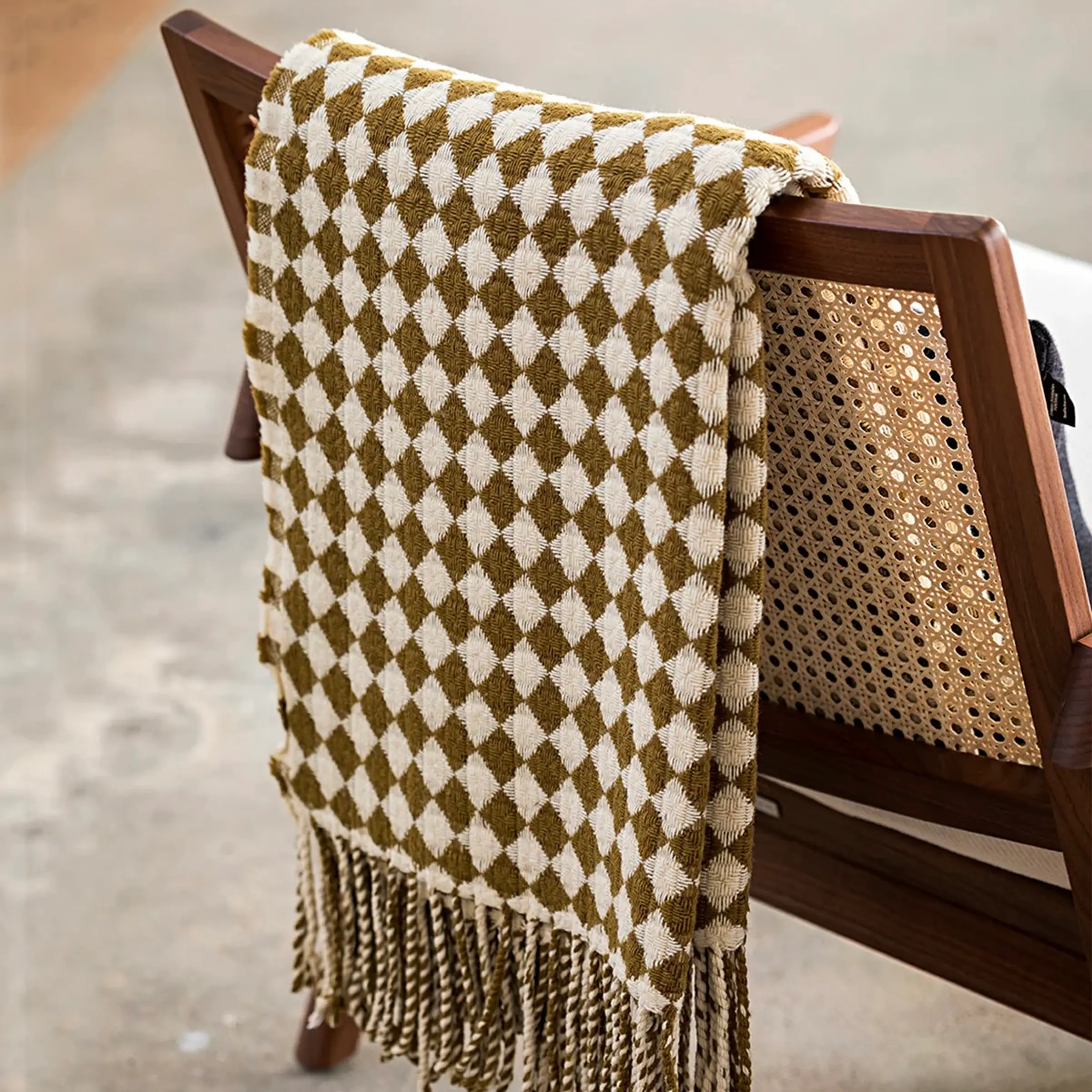 a Burel Factory blanket over the back of a chair