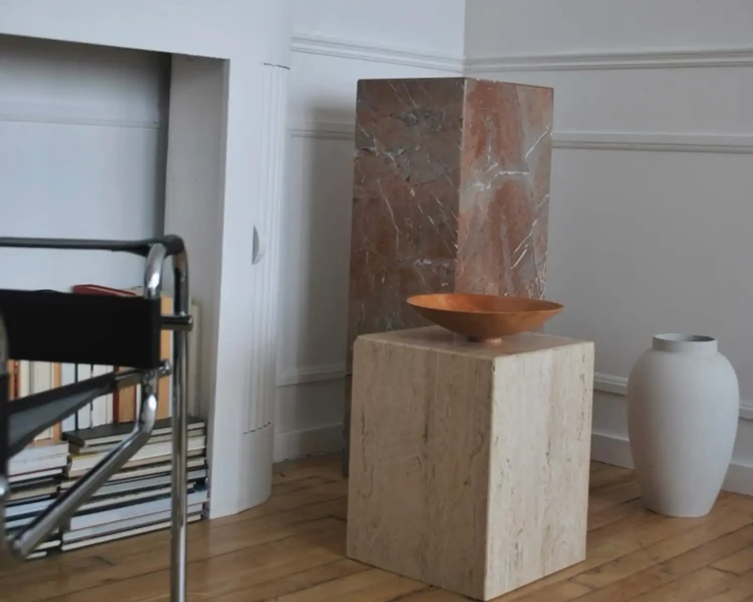 large maple bowl on a marble plinth in a modern living room
