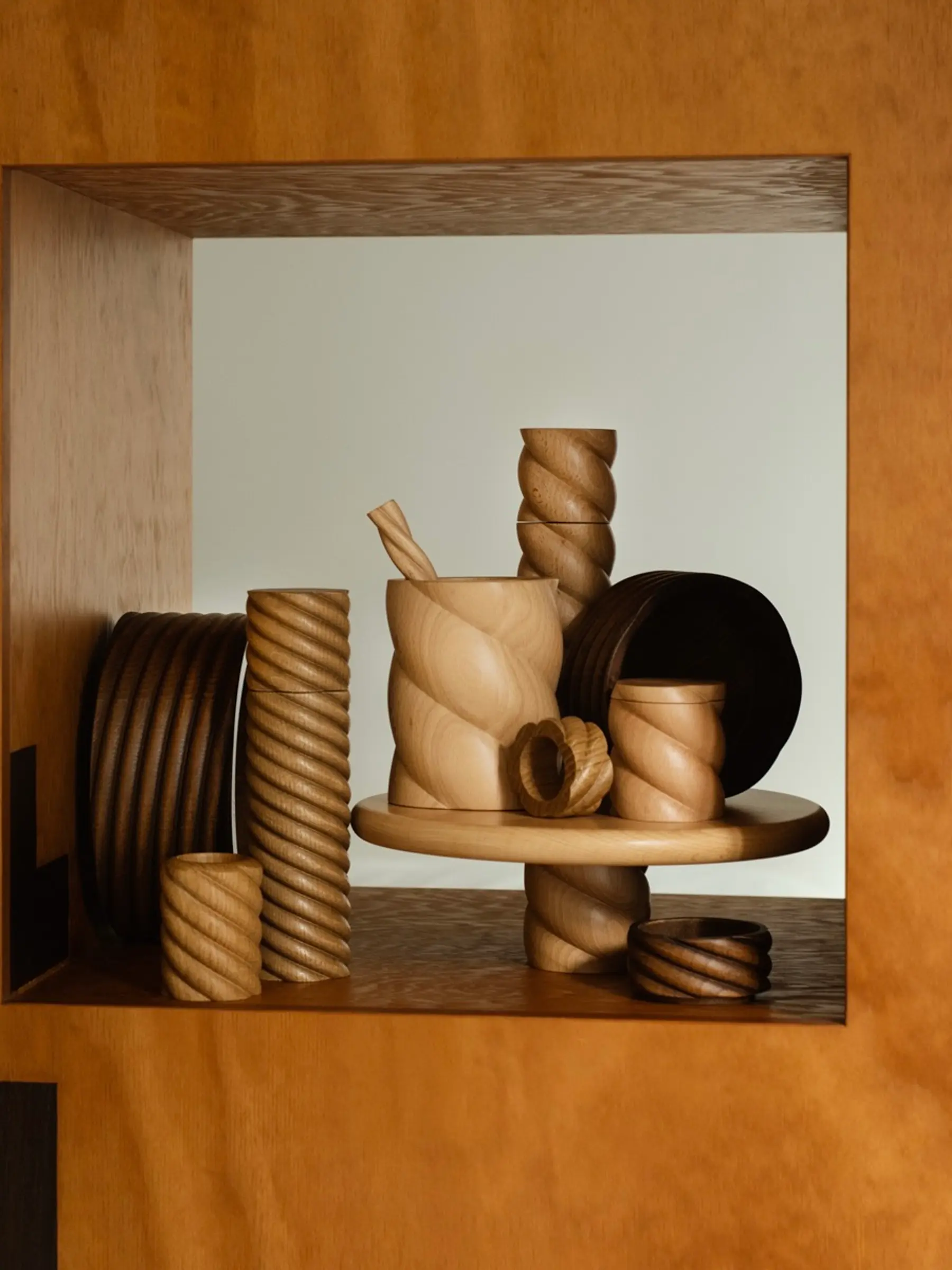 OROS Tornado wooden objects sitting on a square wood shelf