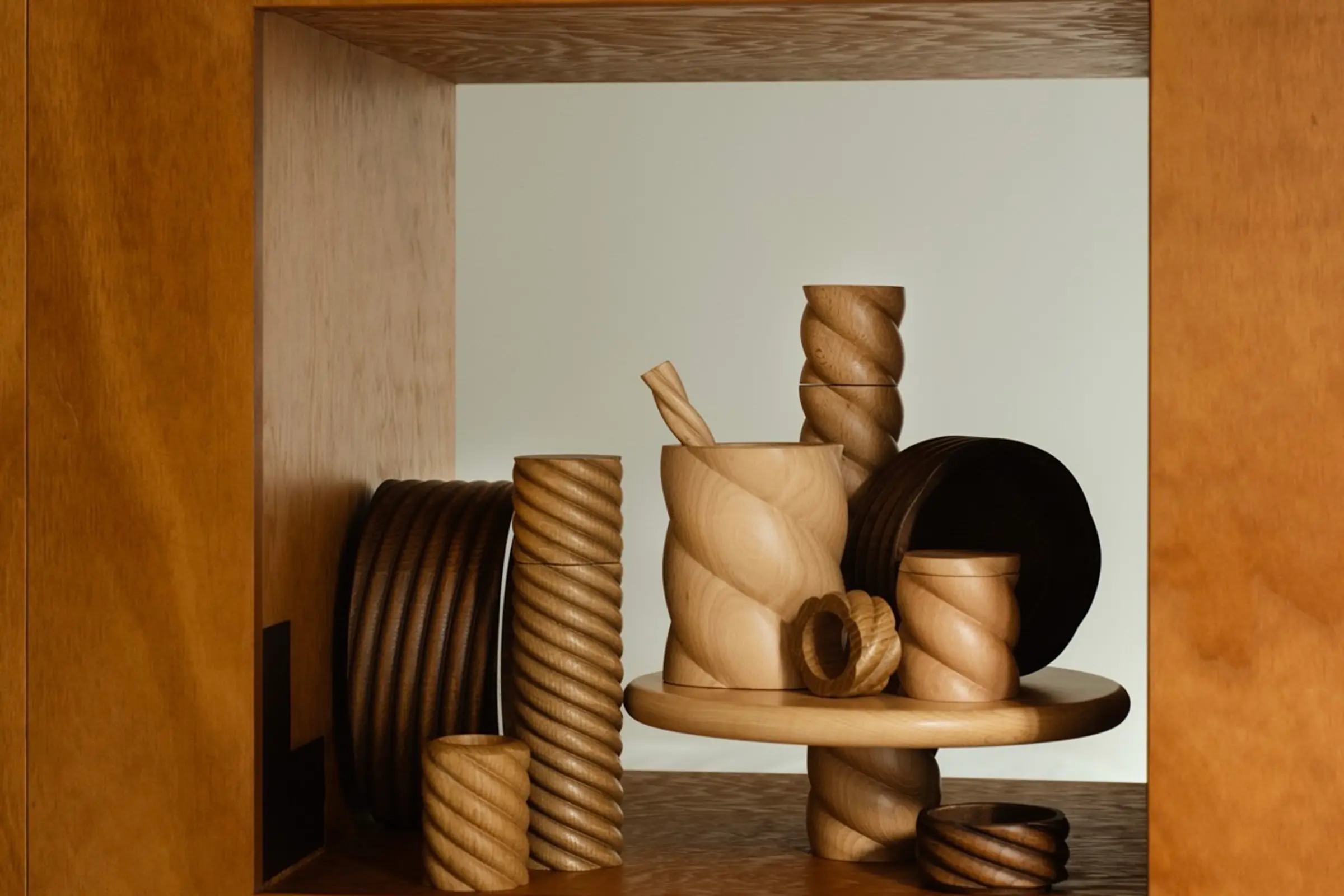 OROS Tornado wooden objects sitting on a square wood shelf