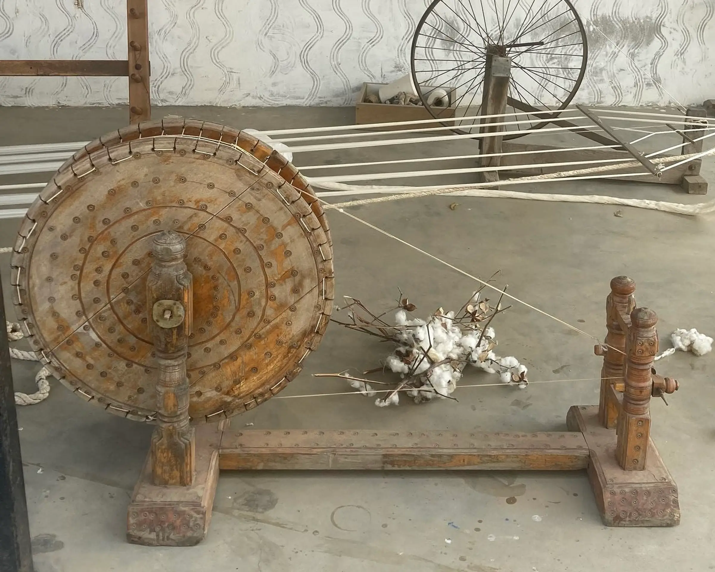 A Charkha spinning wheel in an outside setting in India.
