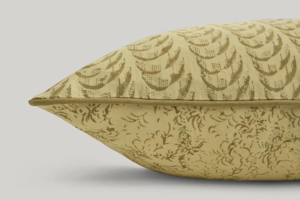 a close up of Studio ford harlequin lumbar cushion is soft buttery yellow