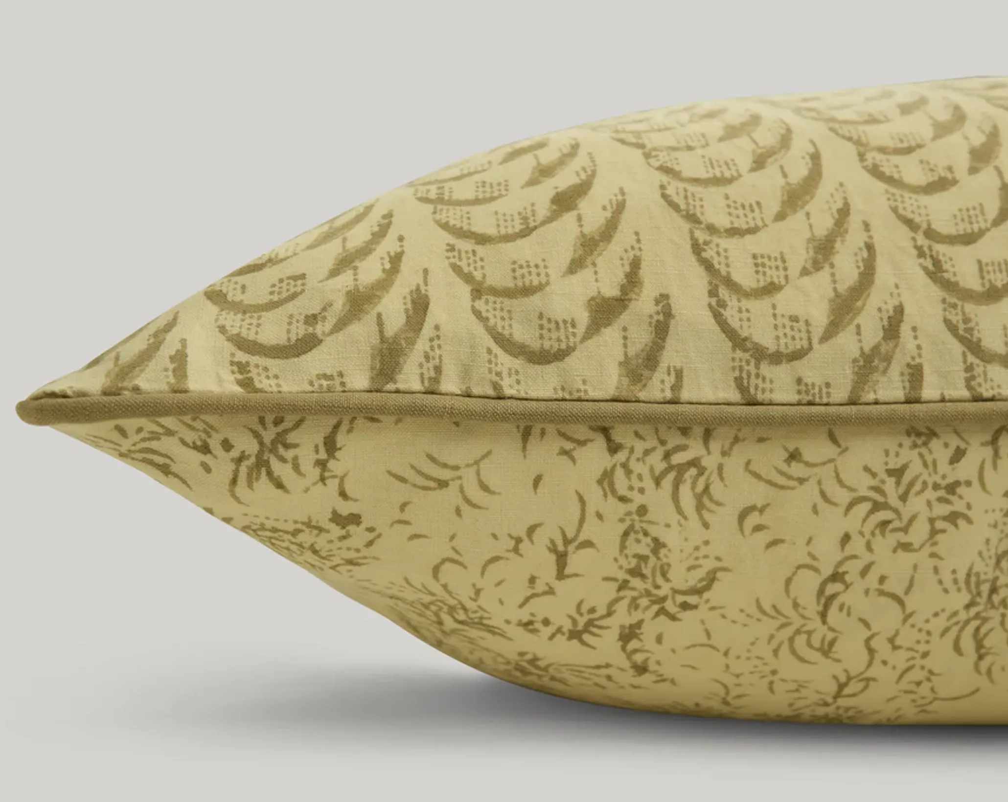 a close up of Studio ford harlequin lumbar cushion is soft buttery yellow