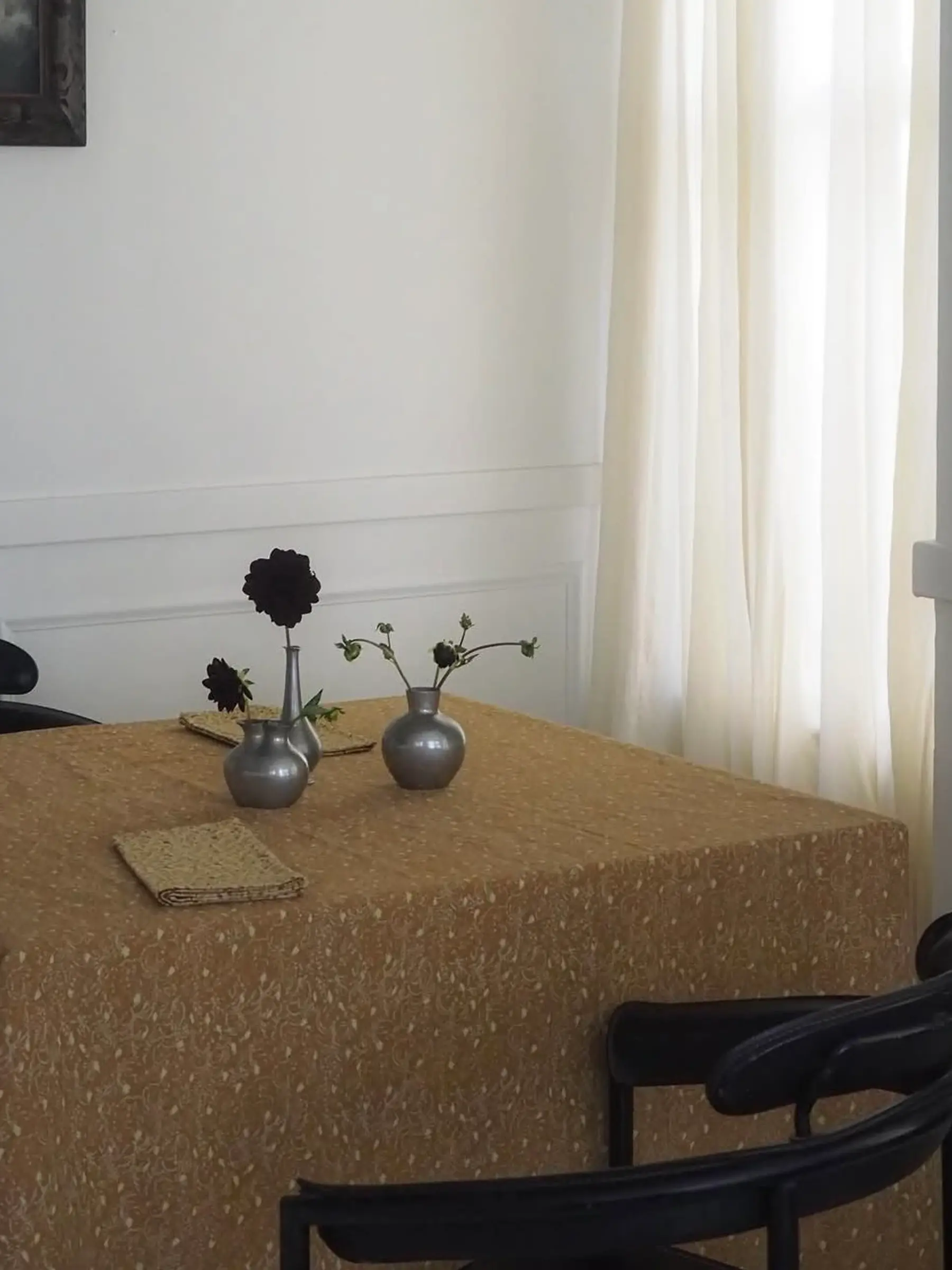 Attendant Studio Ford Tablecloth on a table in a living room with vases and Black Dahlias