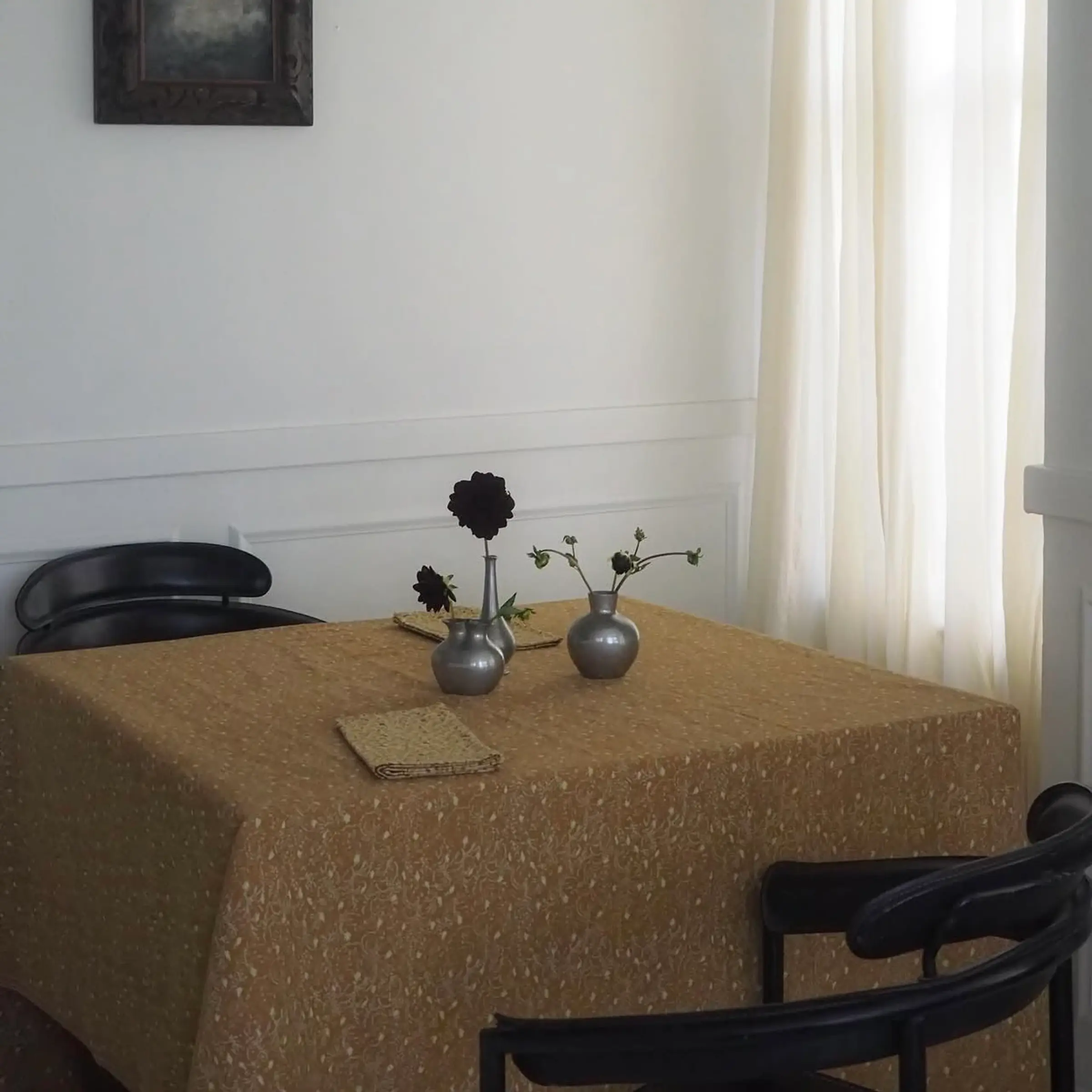 Attendant Studio Ford Tablecloth on a table in a living room with vases and Black Dahlias