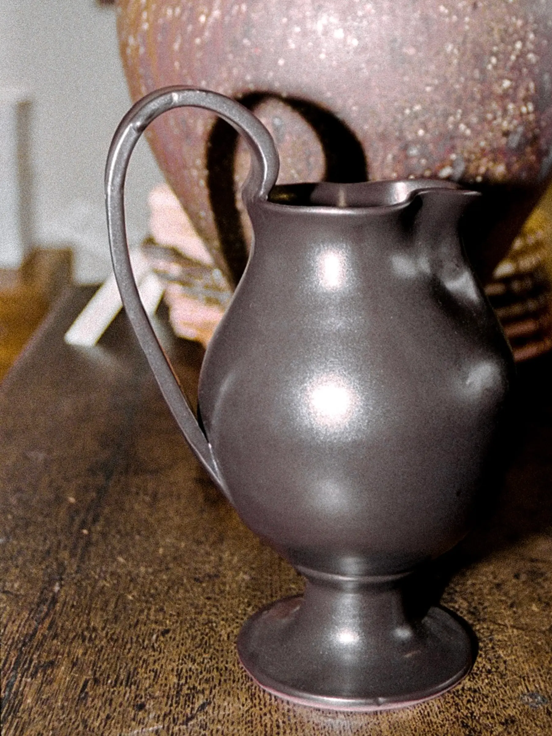 Blackware ceramic Jug in situ with a large vase on a wooden sideboard Aileen Chen.