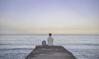 Leon Hong sits by the ocean in Northern Taiwan