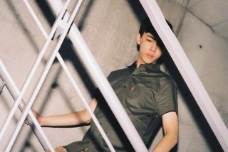 Leon Hong modelling in a green shirt