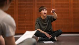 Leon Hong sharing singing techniques with students in a studio