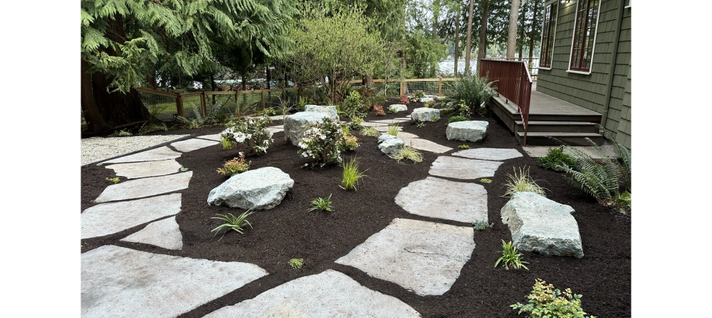 Stone walkway through landscaped yard