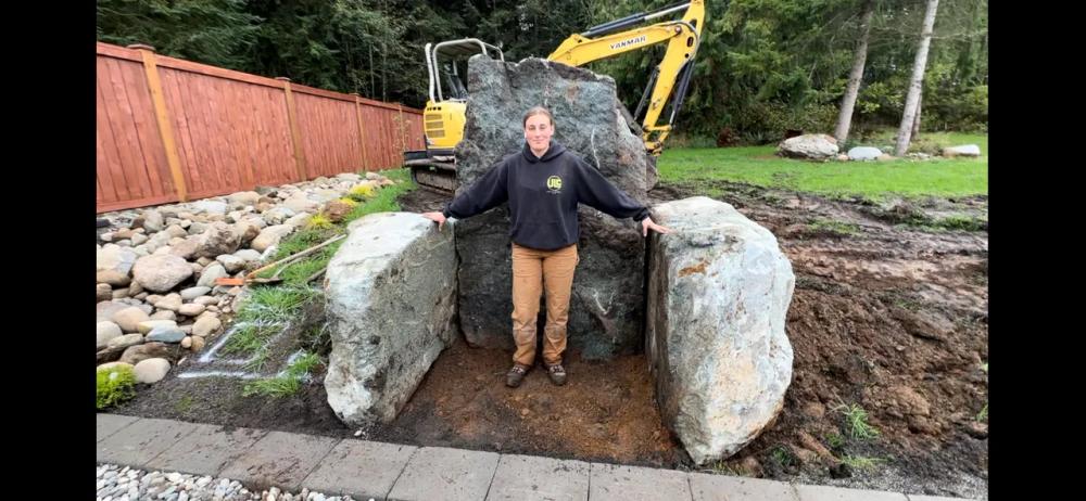 Large boulder placement in residential landscape