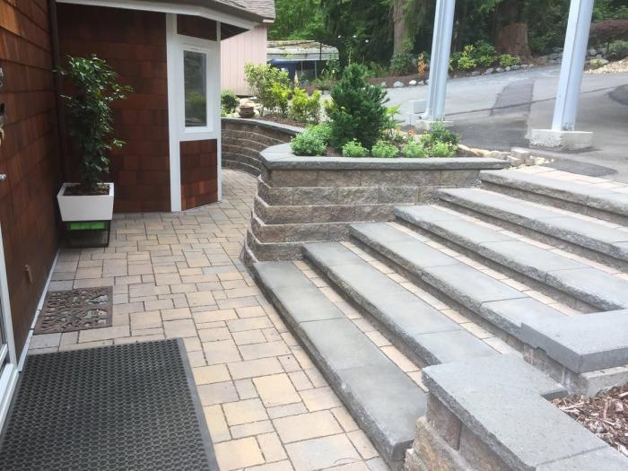 Stone walkway winding through a landscaped yard