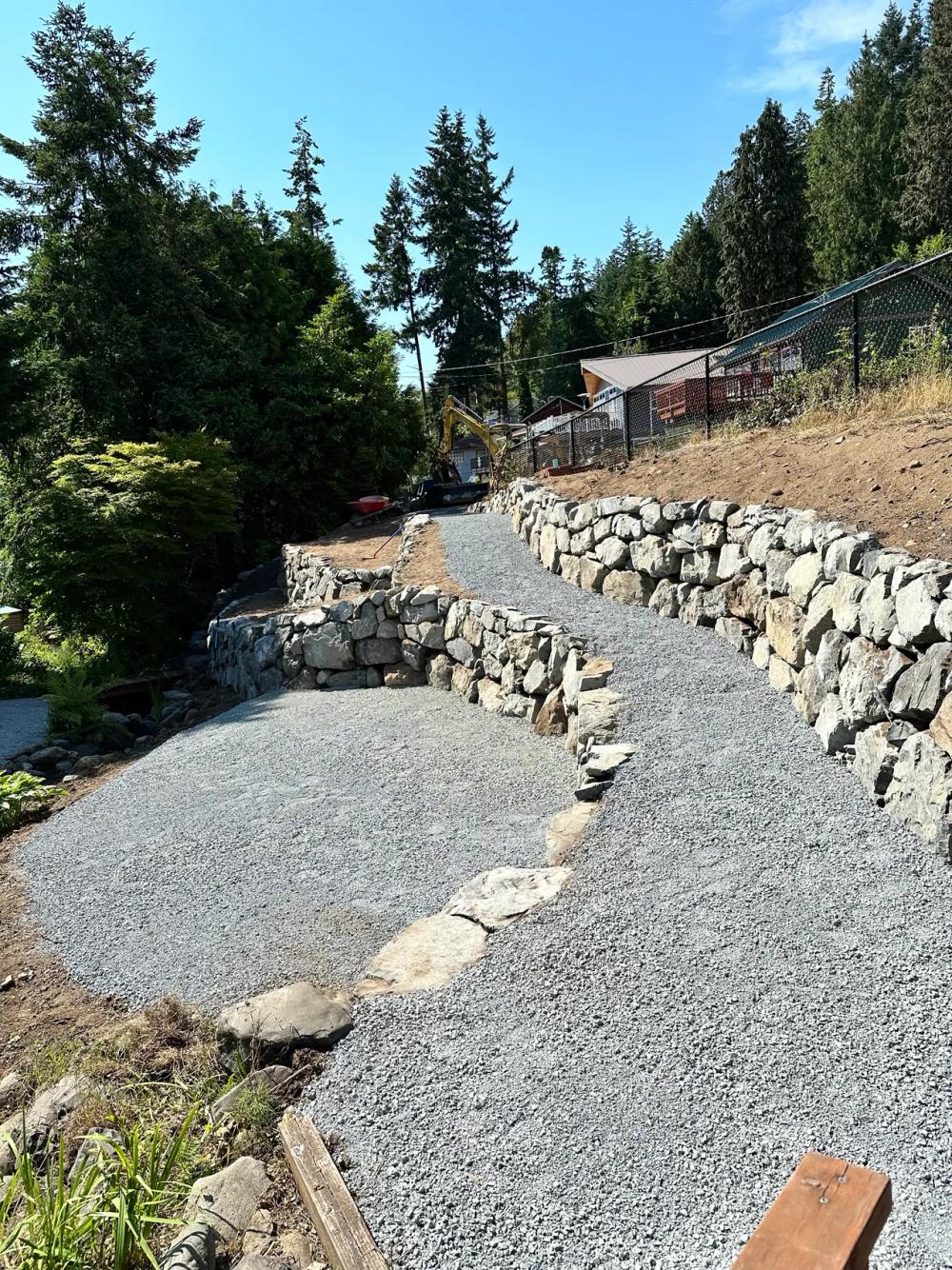 Excavation in progress for retaining wall foundation