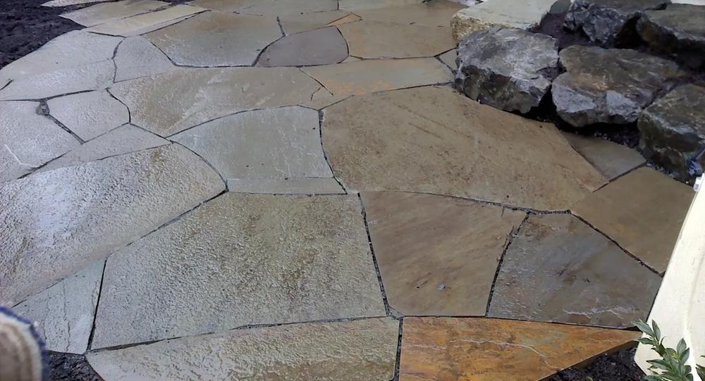 Custom patio design with stone borders