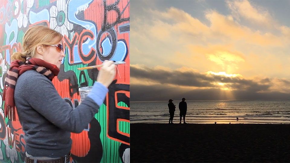artists painting a mural on an exterior wall, looking at a sunset