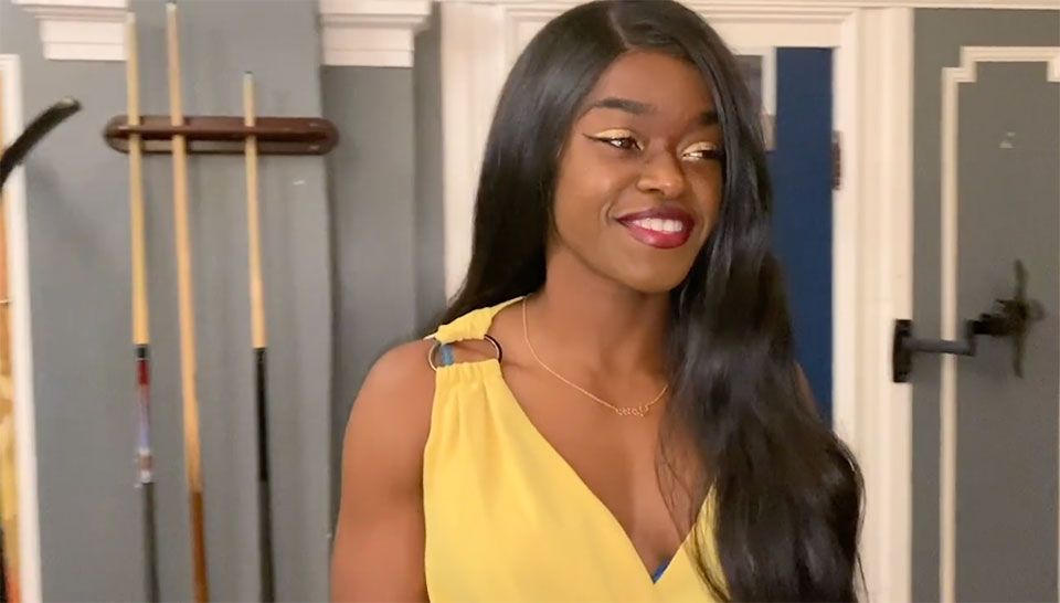 young african-american woman in a fashionable wig and yellow evening gown