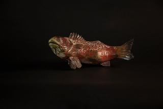 raku fired ceramic work depicting a fish whose environment has become untenable. The glazed surface is meant to evoke diseased or flayed skin, its home having been polluted to the point of boiling. 