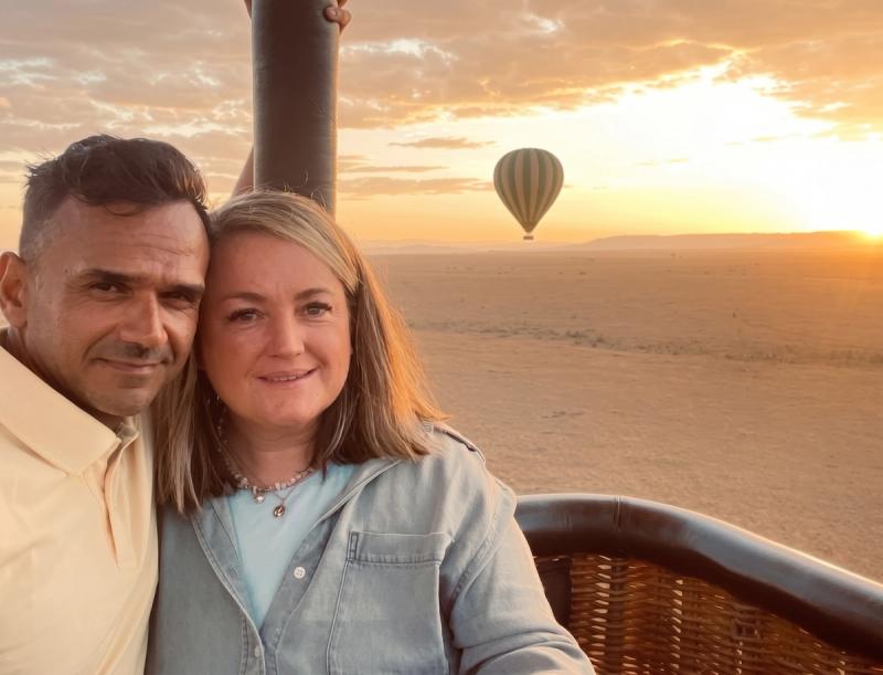 Two guests enjoy the views of the Maasai Mara on a hot air balloon while on a Kenya safari