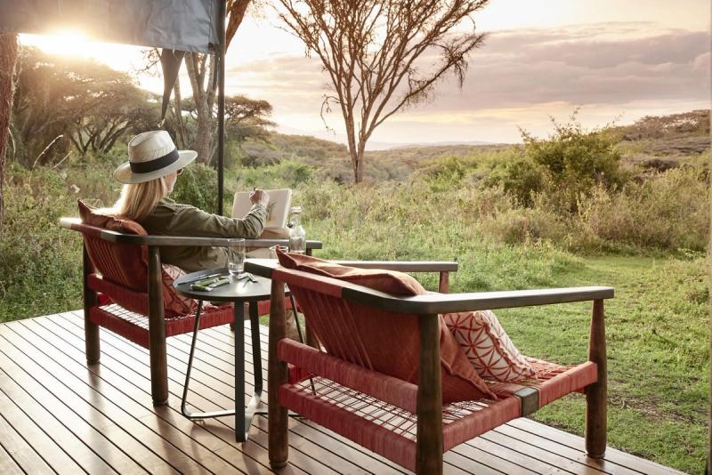 A woman sketches from a shaded safari deck, showing how to stay present by making space to record what moved you – before it fades.